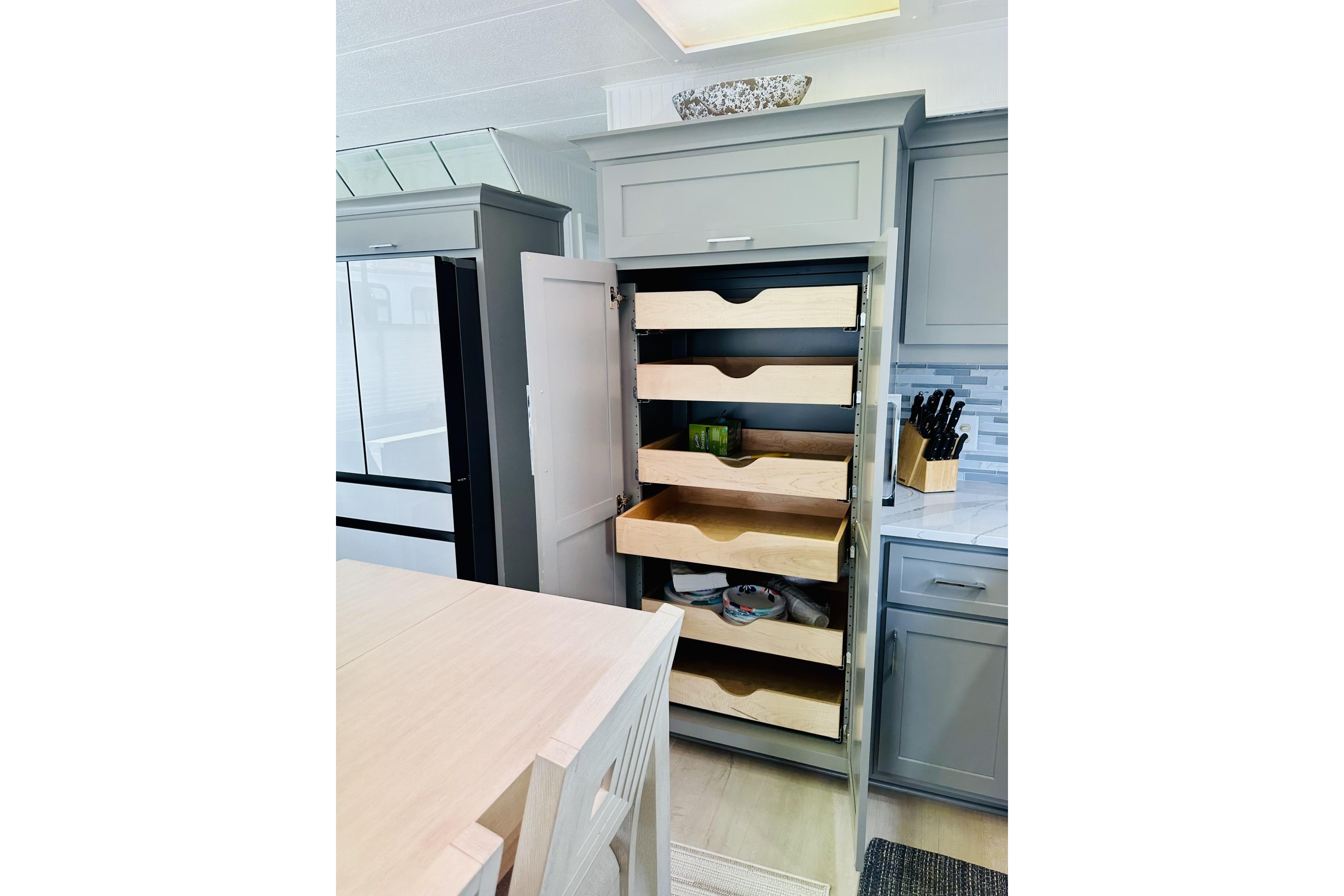 Modern kitchen with open pull-out pantry shelves in a 1992 Sumerset 66 houseboat.