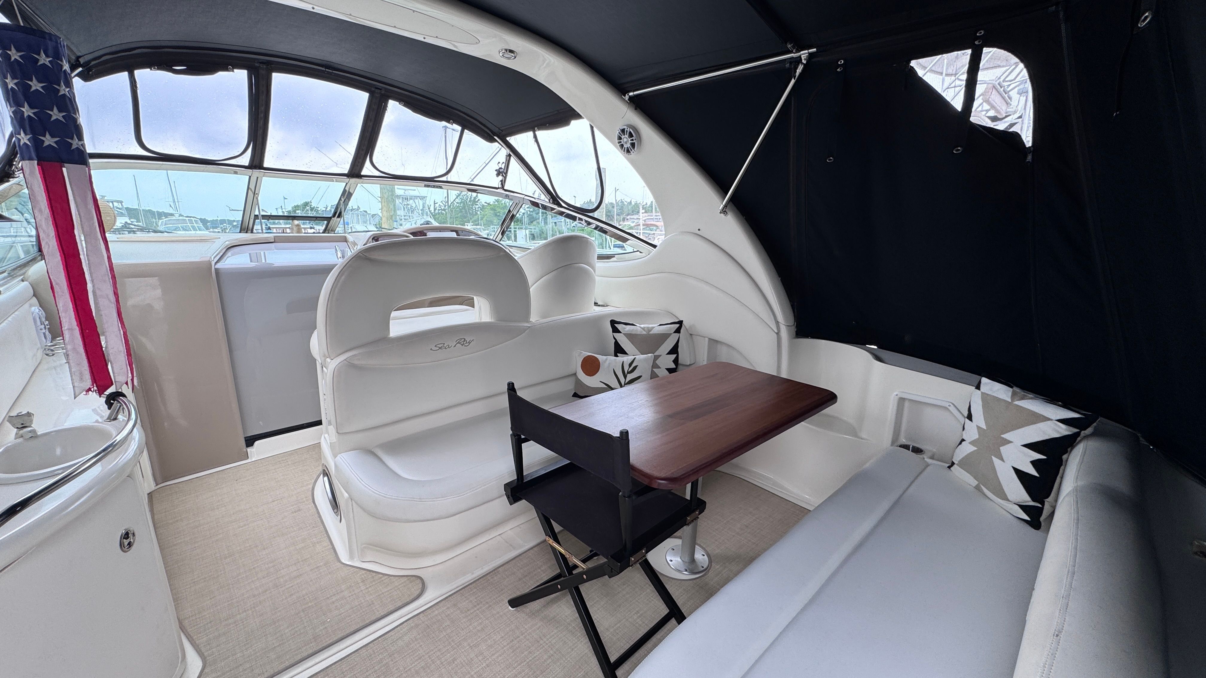 Interior of a 2003 Sea Ray 360 Sundancer with seating area and table.
