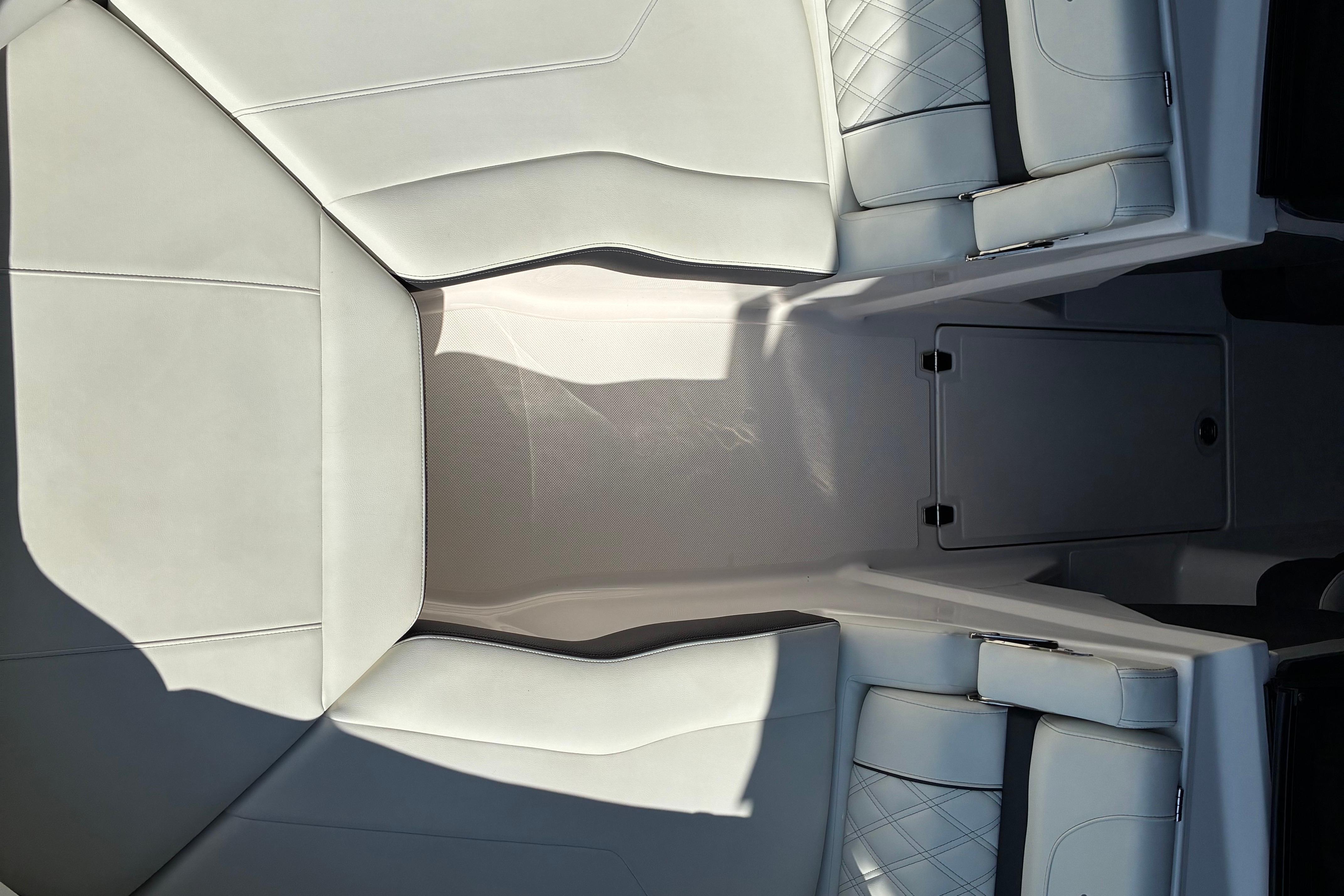 2025 Regal LS2 boat interior with white leather seating and storage compartment.