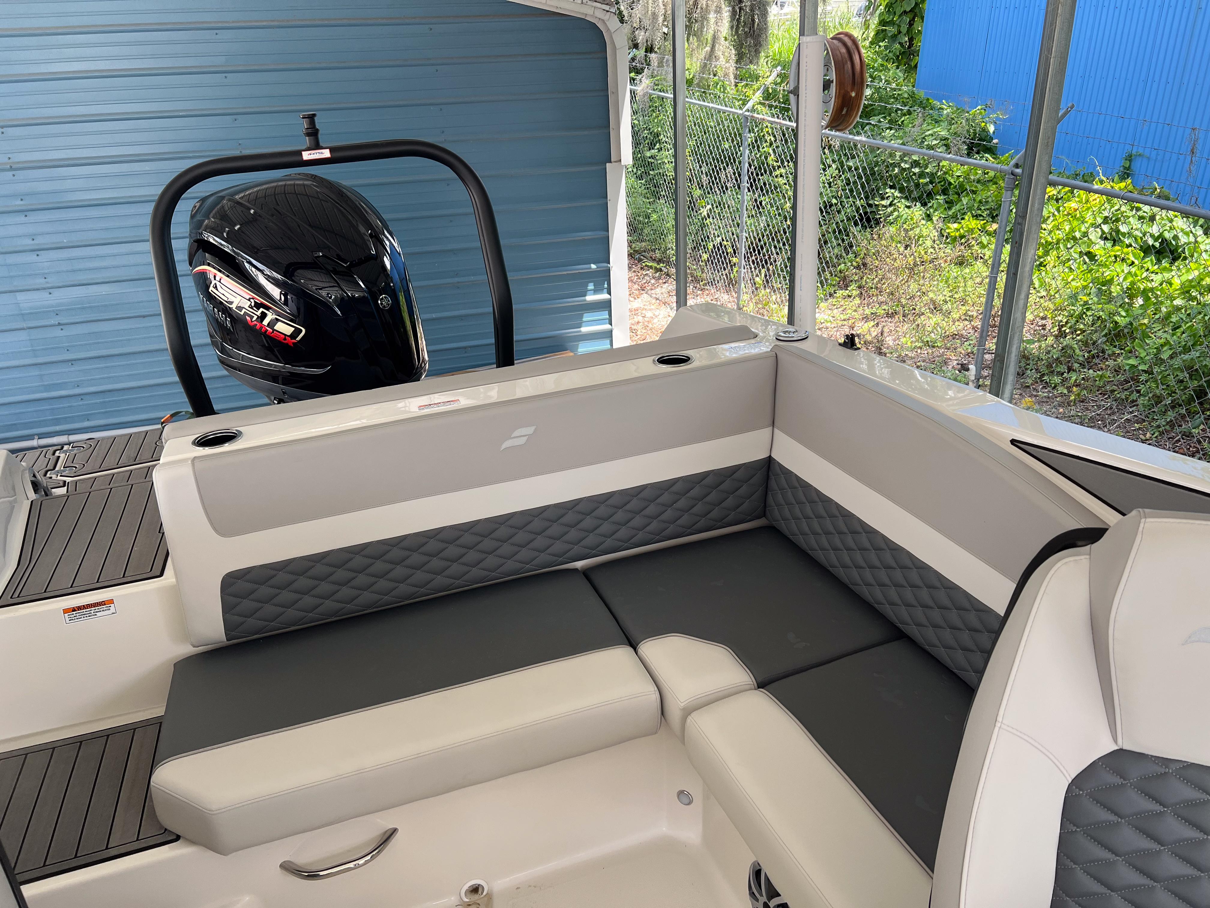 2026 Starcraft SVX 231 OB boat interior with cushioned seating and outboard motor.