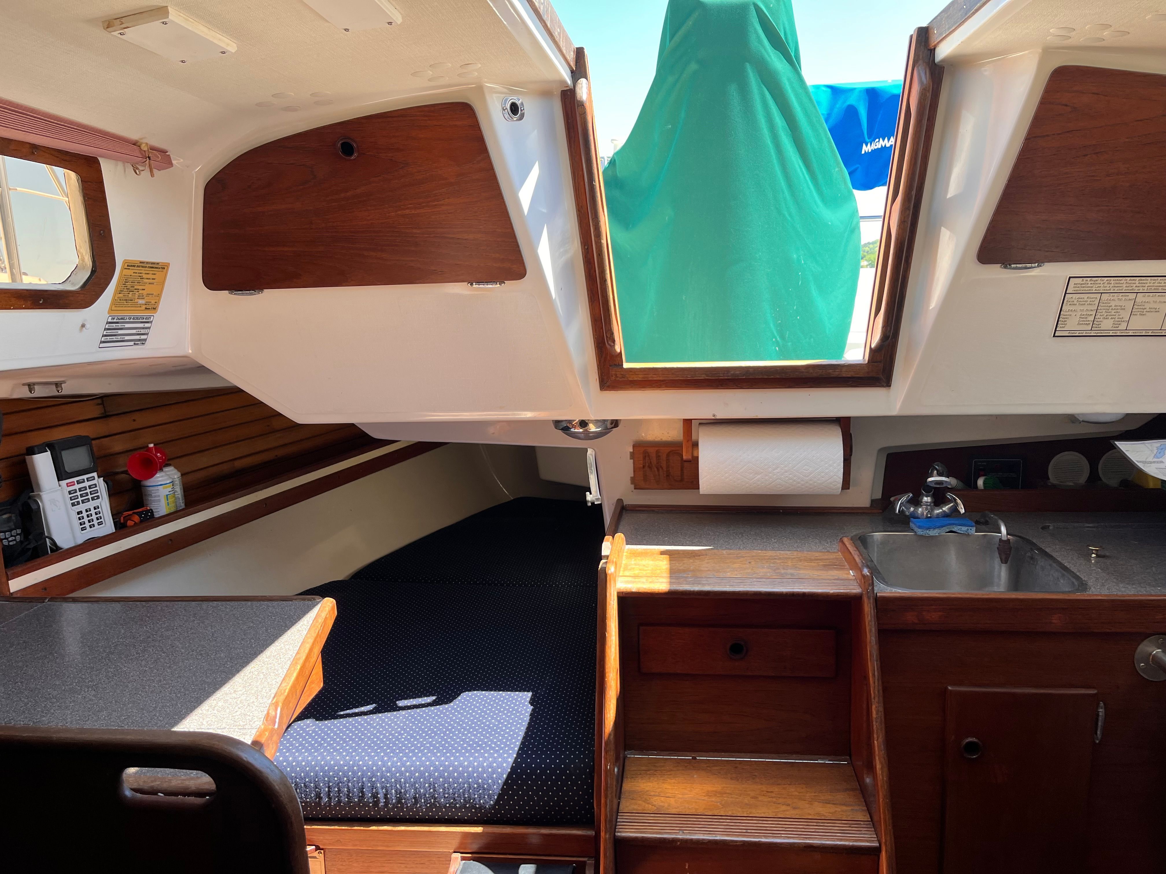 Interior of a 1989 Sabre 30 III yacht with sleeping area and kitchenette.