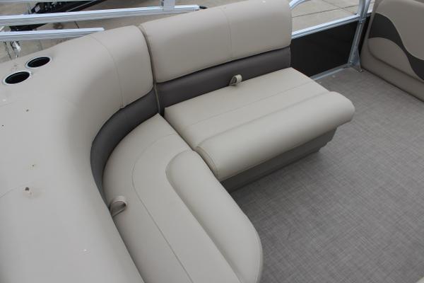2025 Sun Tracker Party Barge 18 DLX interior seating with beige upholstery.