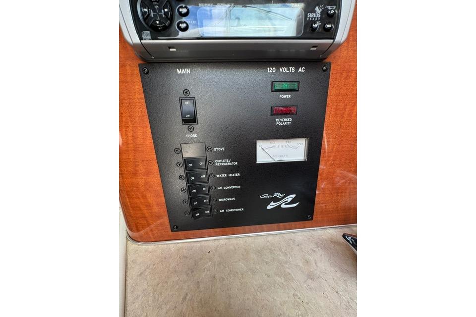 Control panel of a 2004 Sea Ray 240 Sundancer boat, featuring switches and indicators.