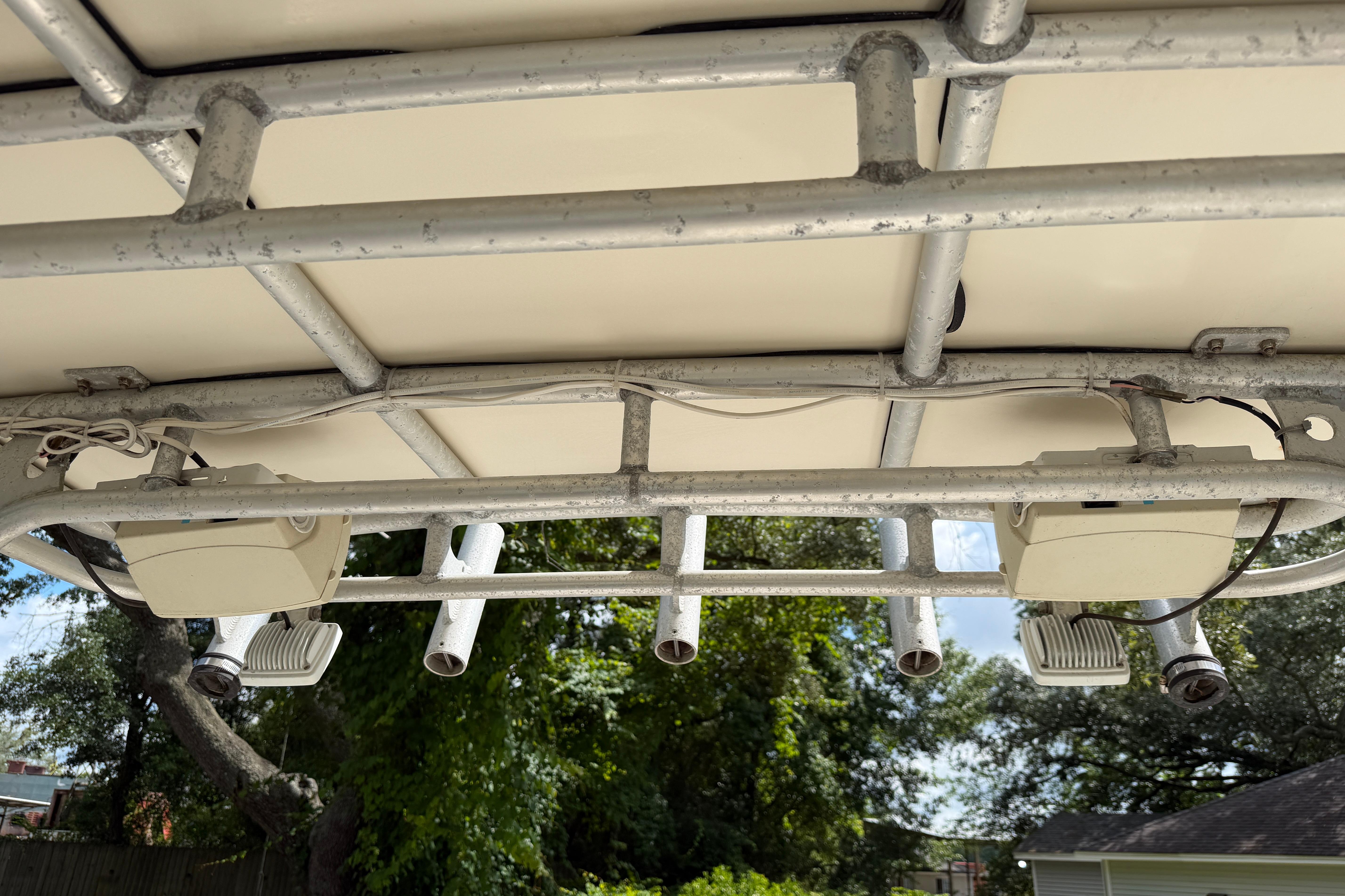 1987 Grady-White Seafarer 226 boat canopy with mounted lights and rod holders.