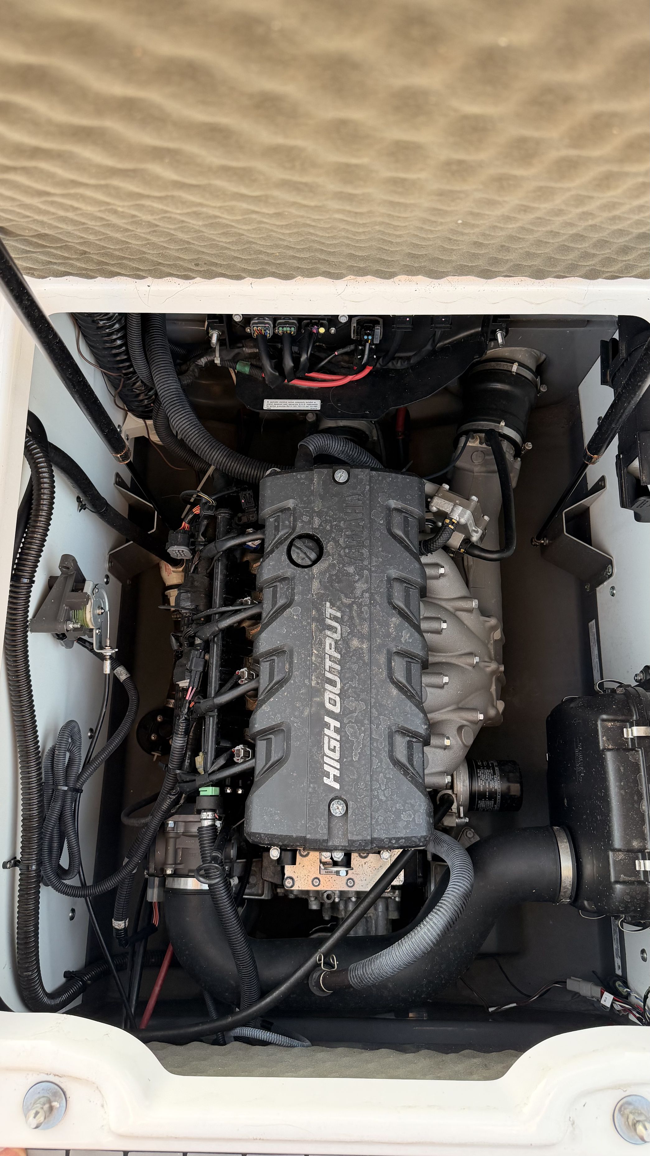 The engine compartment of a 2019 Yamaha 190 FSH Sport boat with a high output engine.