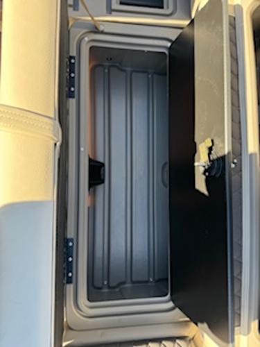 Interior view of 2025 Sun Tracker Fishin' Barge 22 DLX storage compartment.