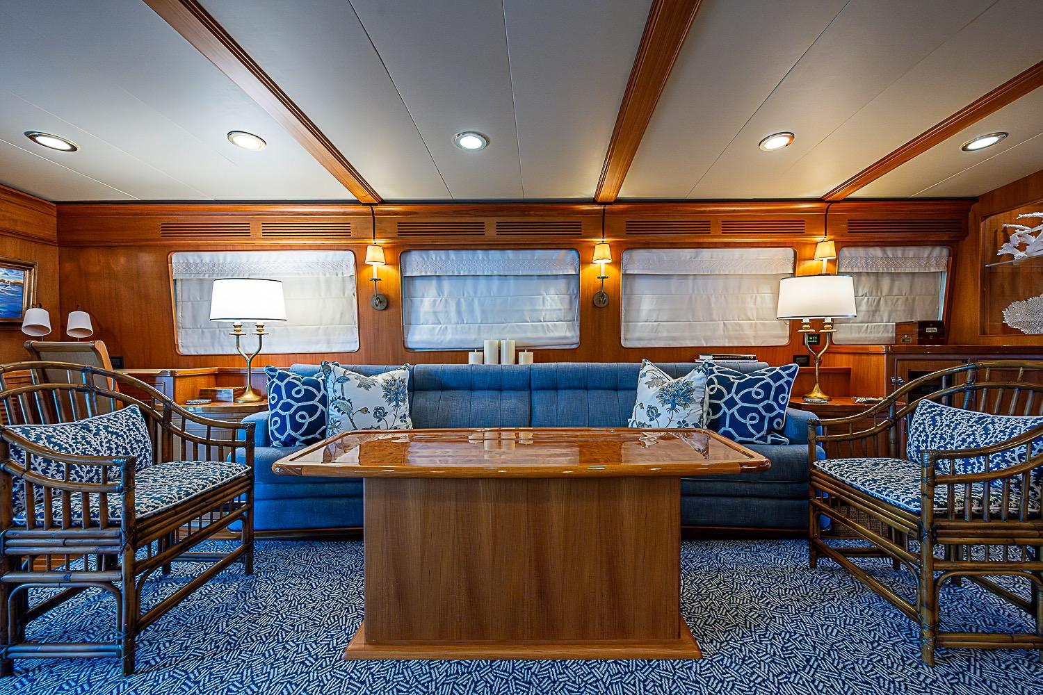 Luxurious interior of 2014 Marlow 80 Explorer yacht with elegant seating and wooden accents.