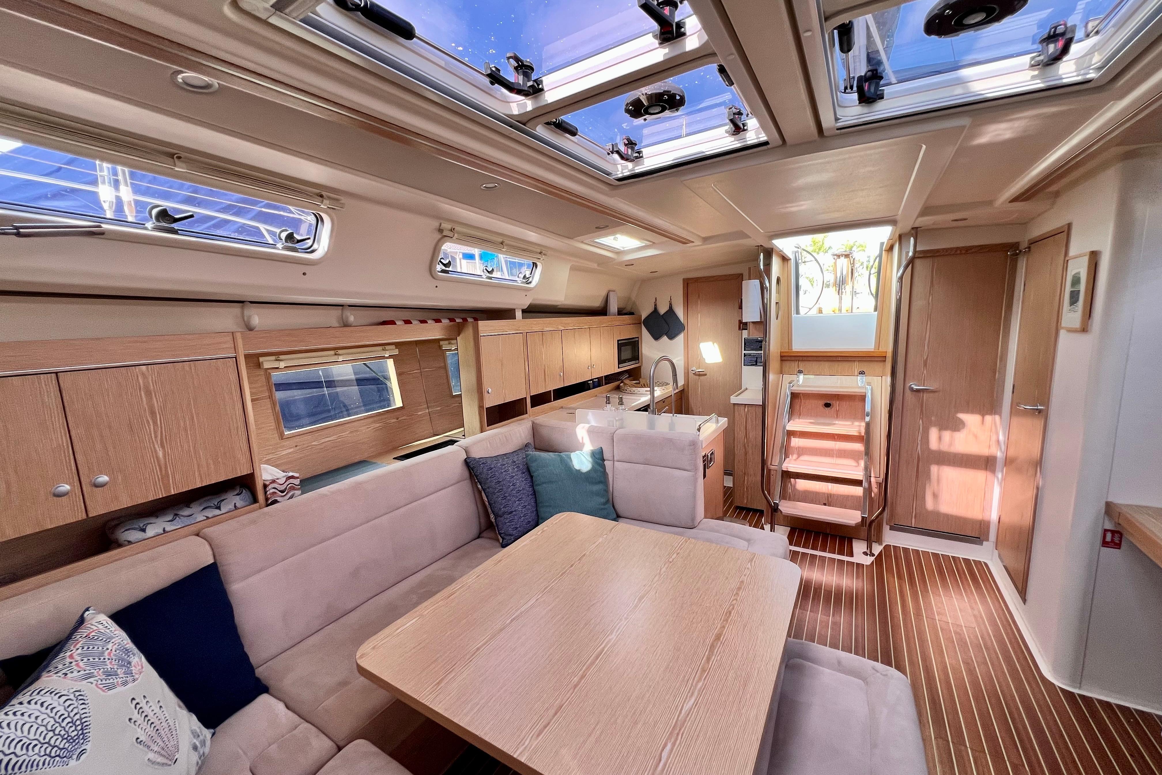 Luxurious interior of 2016 Hanse 455 yacht with modern furnishings and ample natural light.