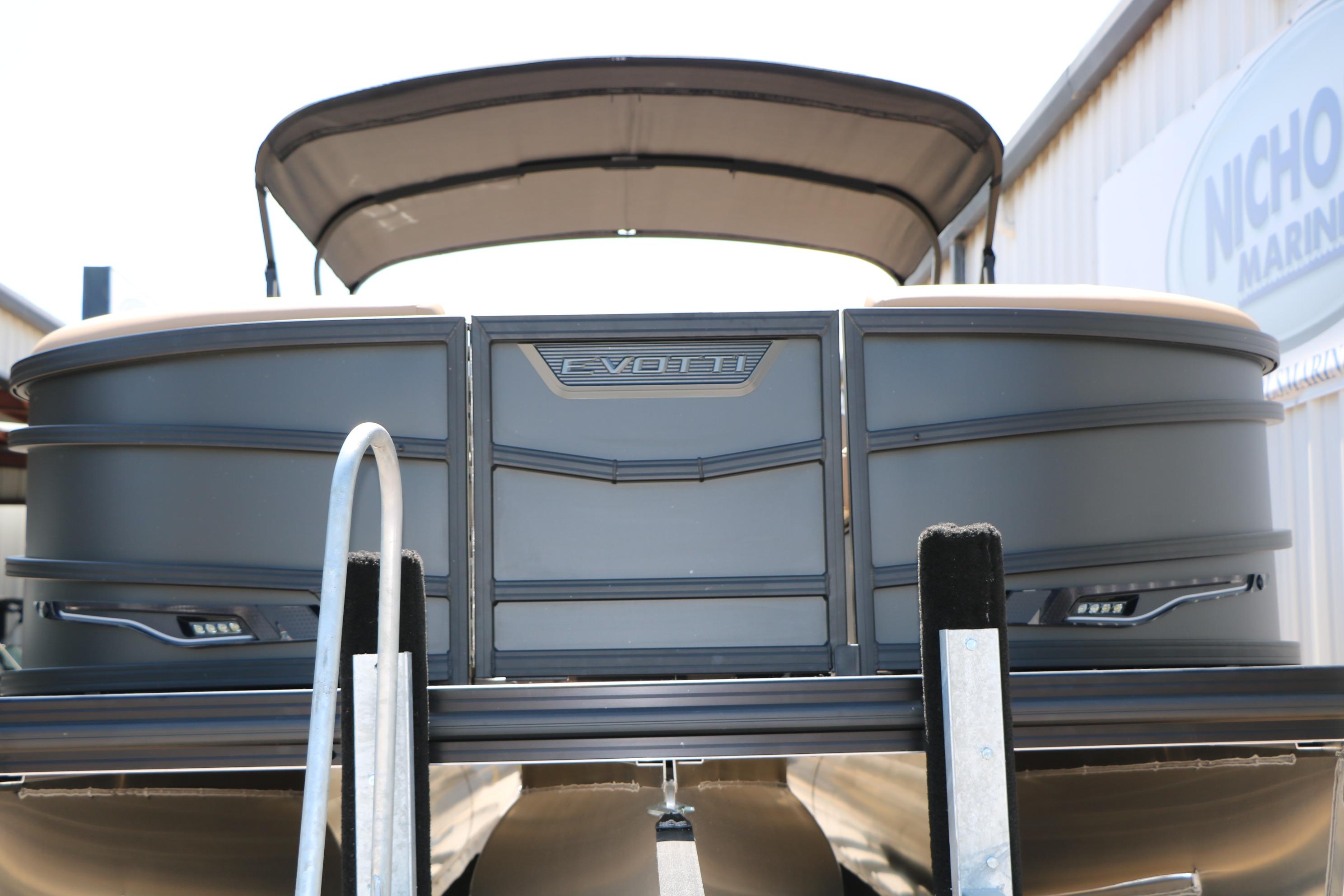 2026 Evotti 725 CS Tri-Toon boat with canopy, docked at marina.