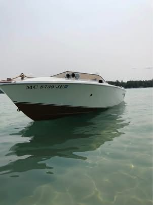 A 1972 Chris-Craft XK-19 on calm water.
