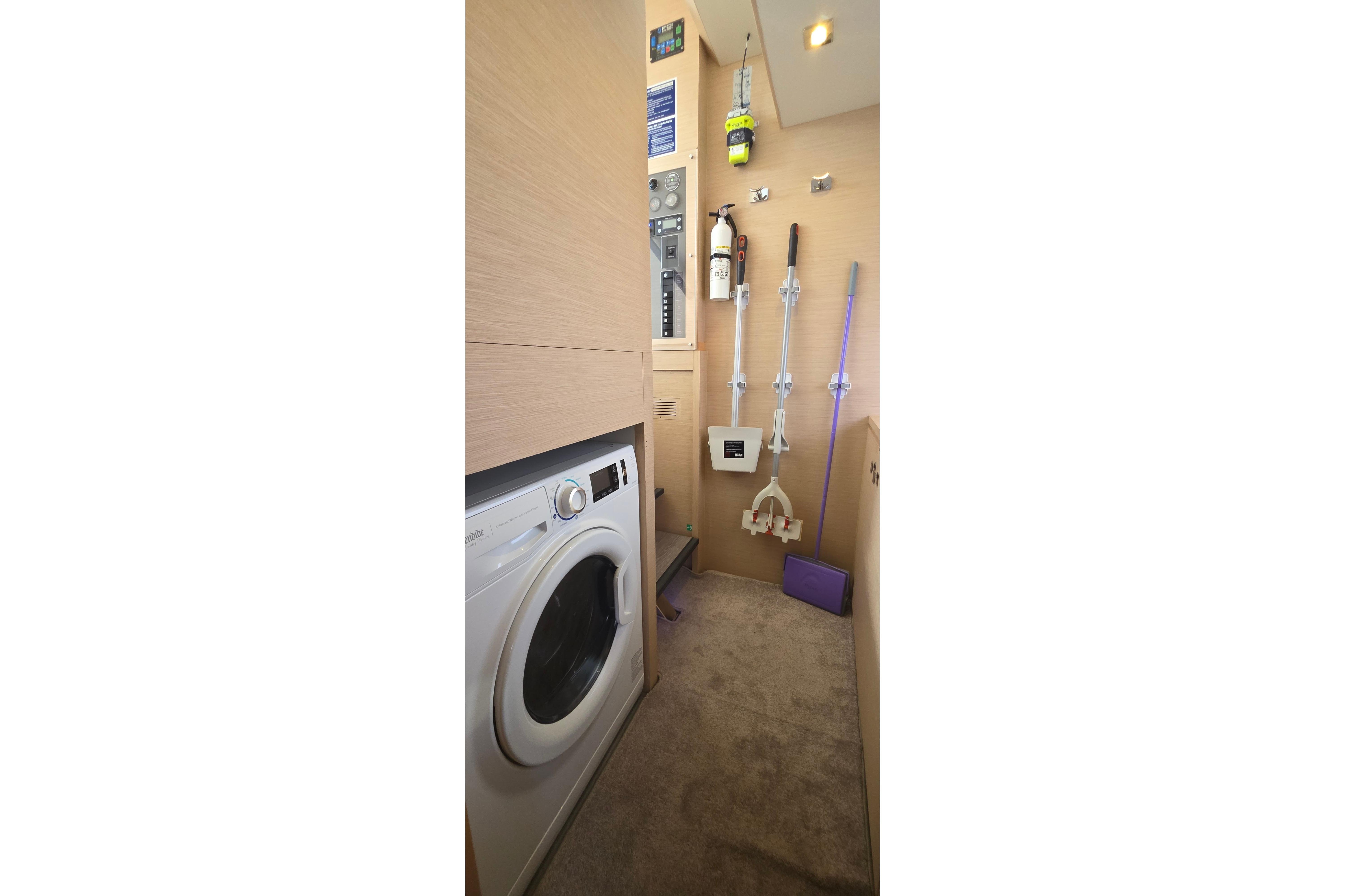 Laundry area on 2018 Fountaine Pajot Motor Yacht 44 with washer and cleaning tools.