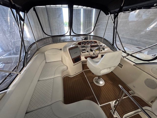 Interior of a 2004 Meridian 341 Sedan with elegant white seating and wood flooring.