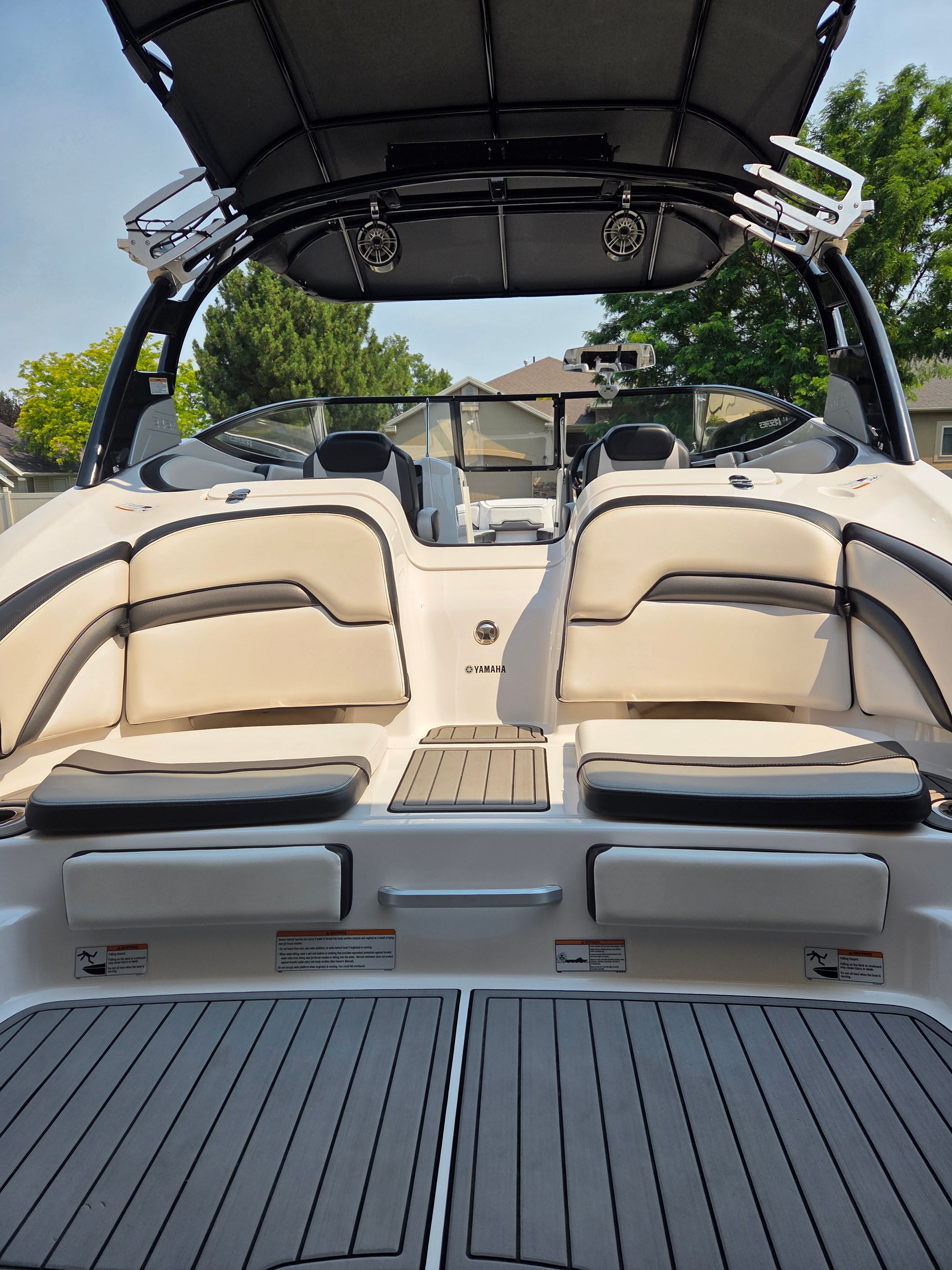 The image shows the stern of a 2016 Yamaha 242X E-Series boat with cushioned seating.