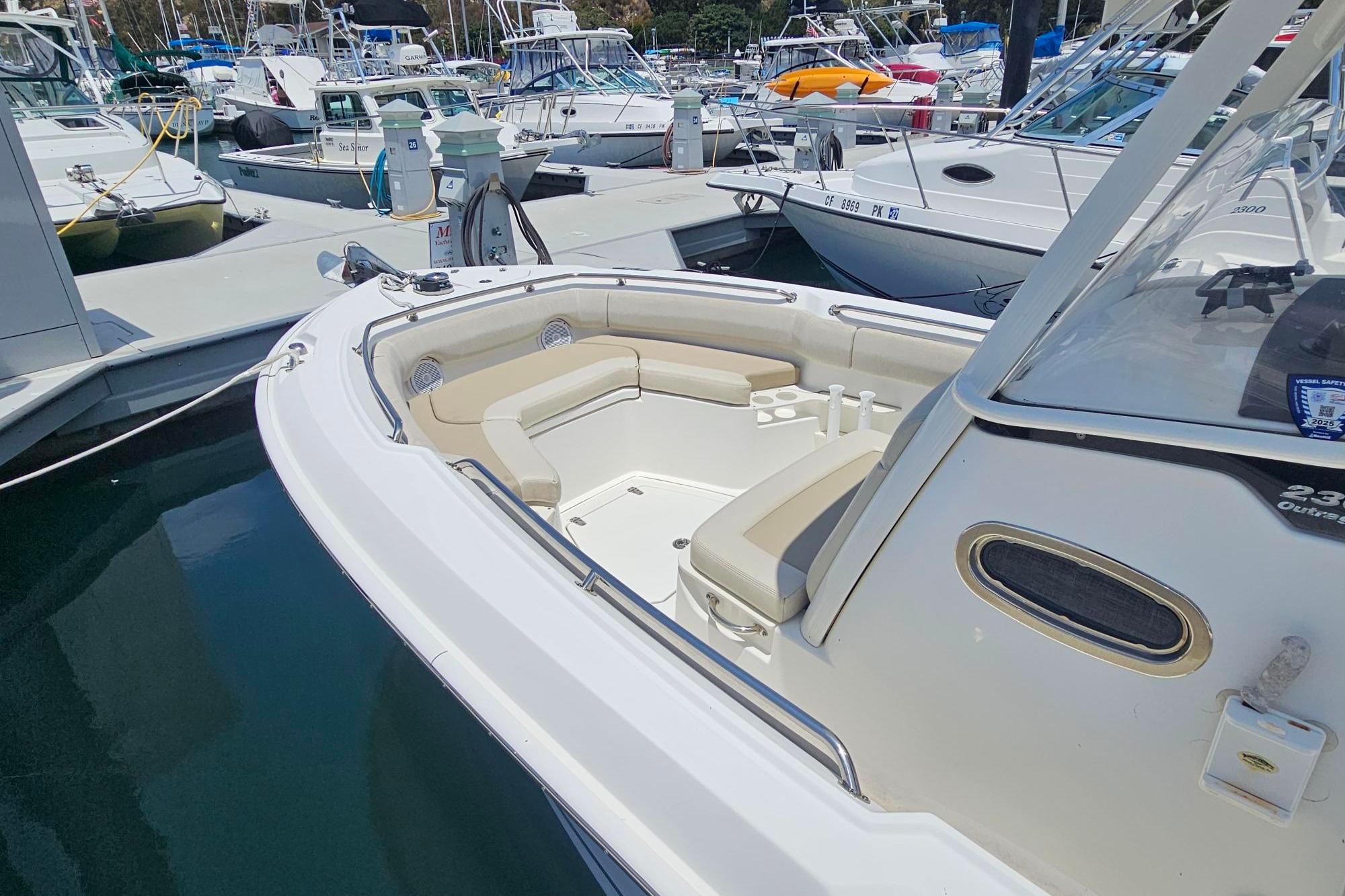 2017 Boston Whaler 230 Outrage boat docked, featuring spacious seating and sleek design.