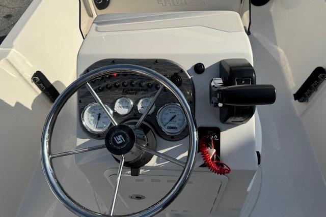 Steering console of 2026 Carolina Skiff 192 JLS boat with gauges and controls.