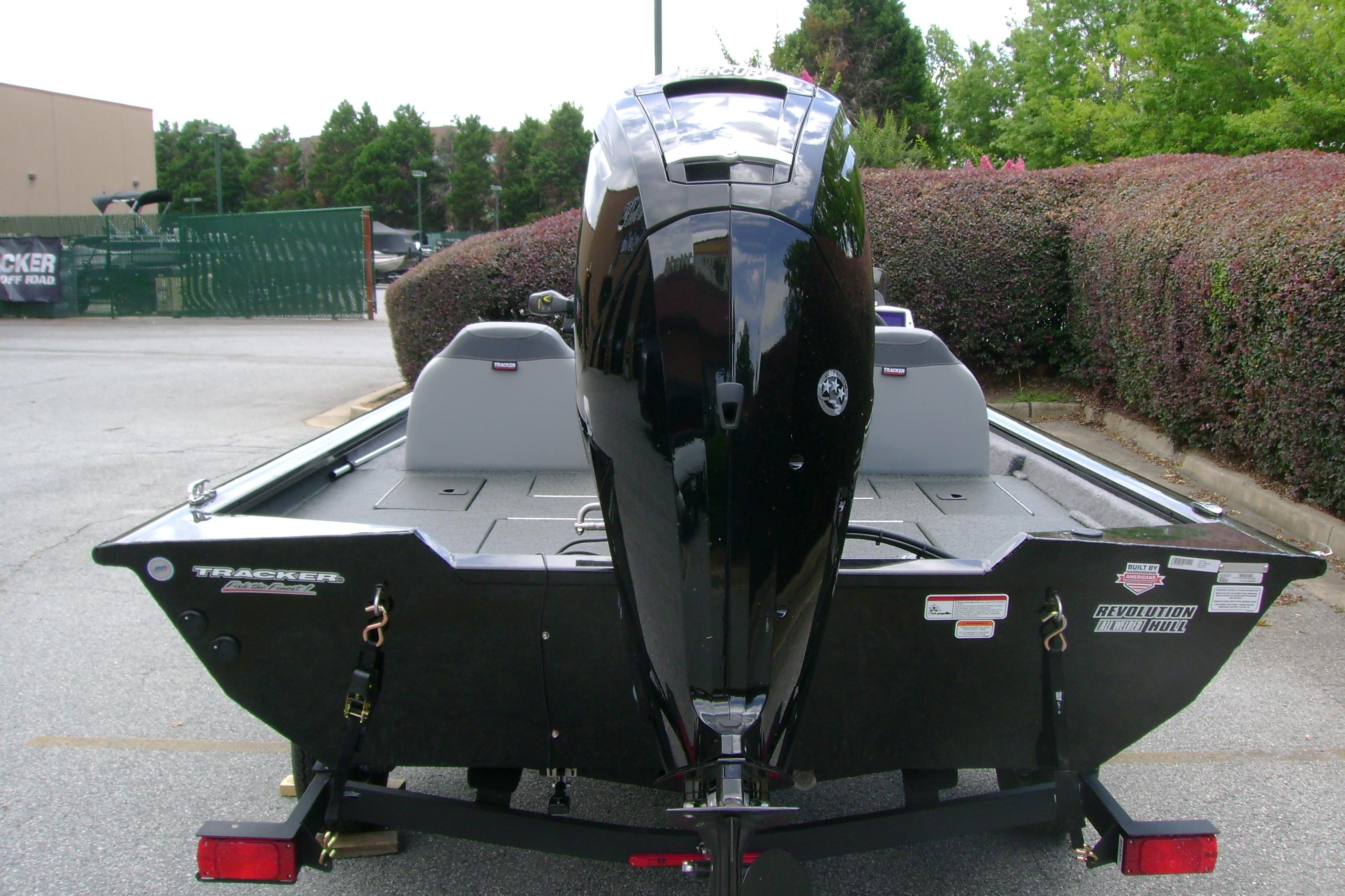 2026 Tracker Pro Team 175 boat with outboard motor, parked outdoors.
