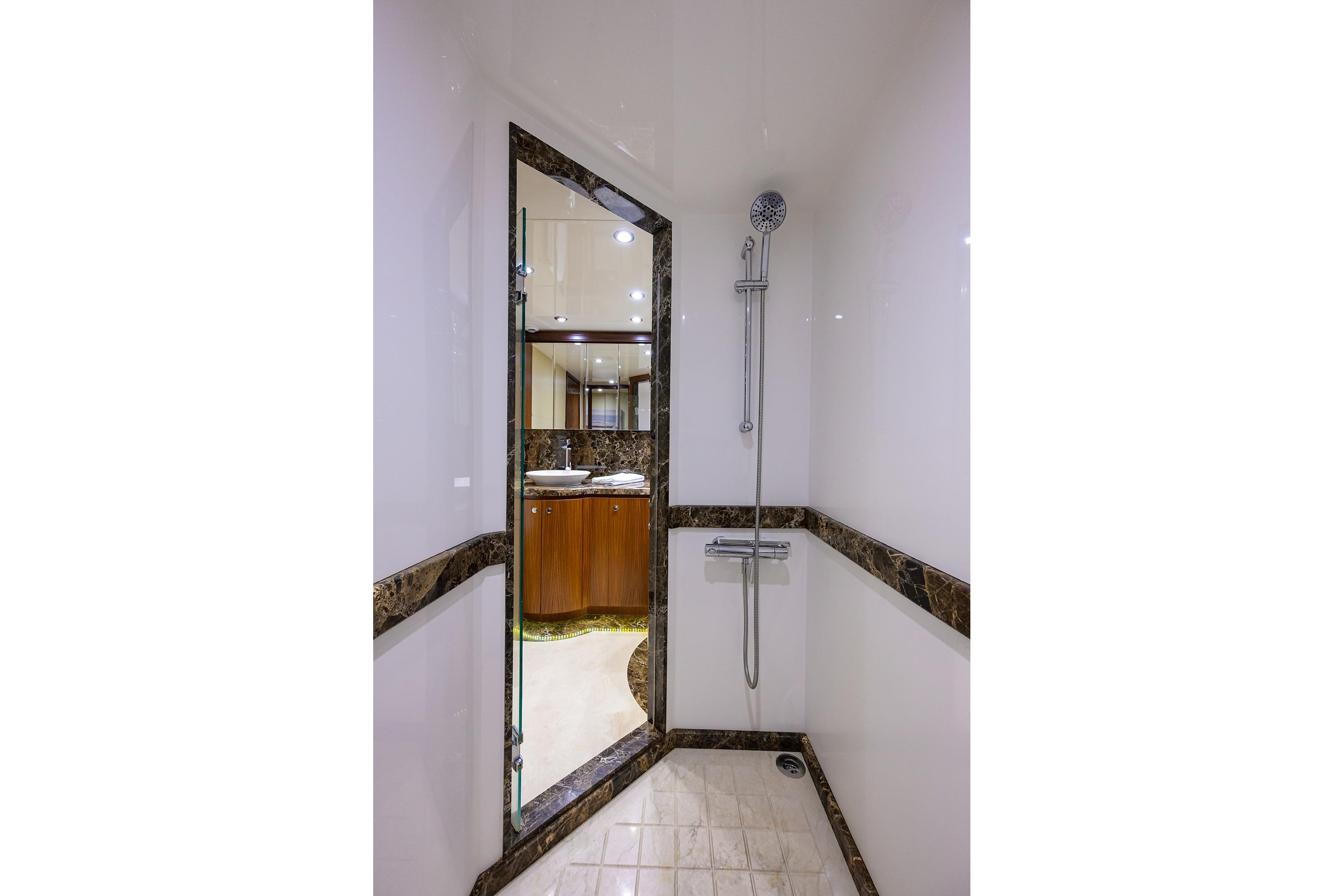 Luxurious shower area in 2016 Ocean Alexander 72 Pilothouse yacht bathroom.