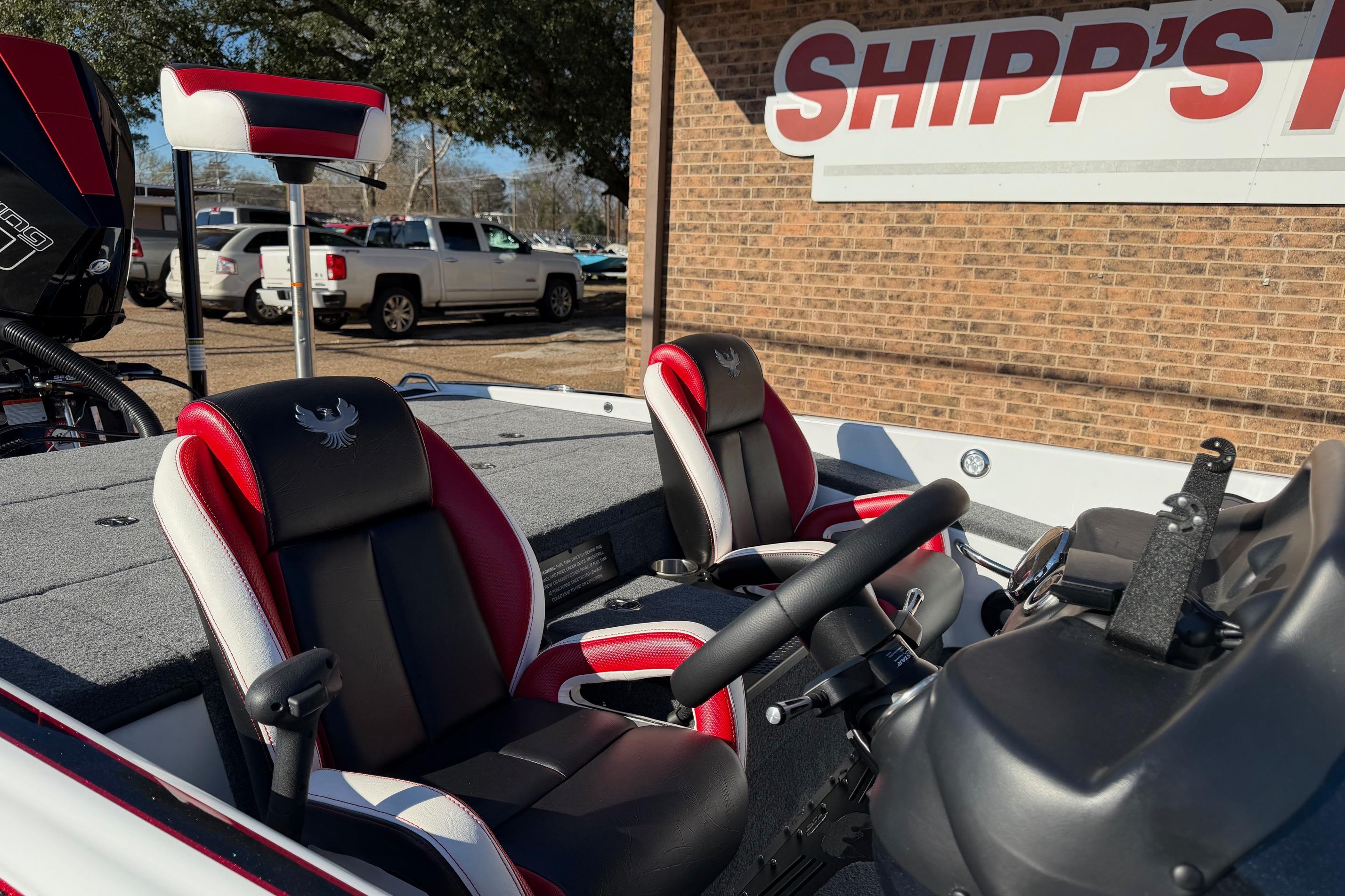 2024 Phoenix 921 Elite II boat interior with red and black seats at Shipp's location.