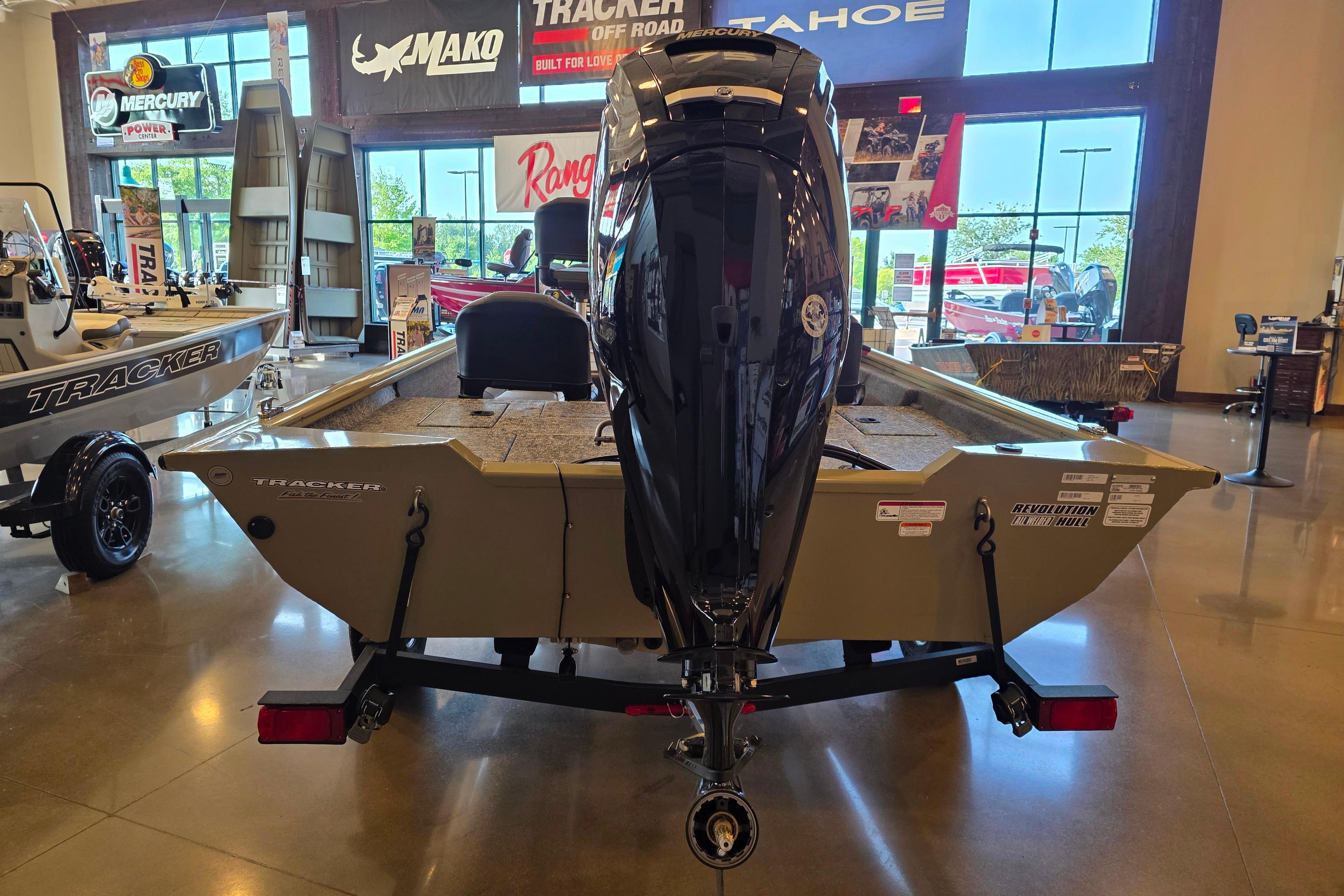 2026 Tracker Pro Team 175 Crappie Edition boat displayed in showroom with Mercury engine.