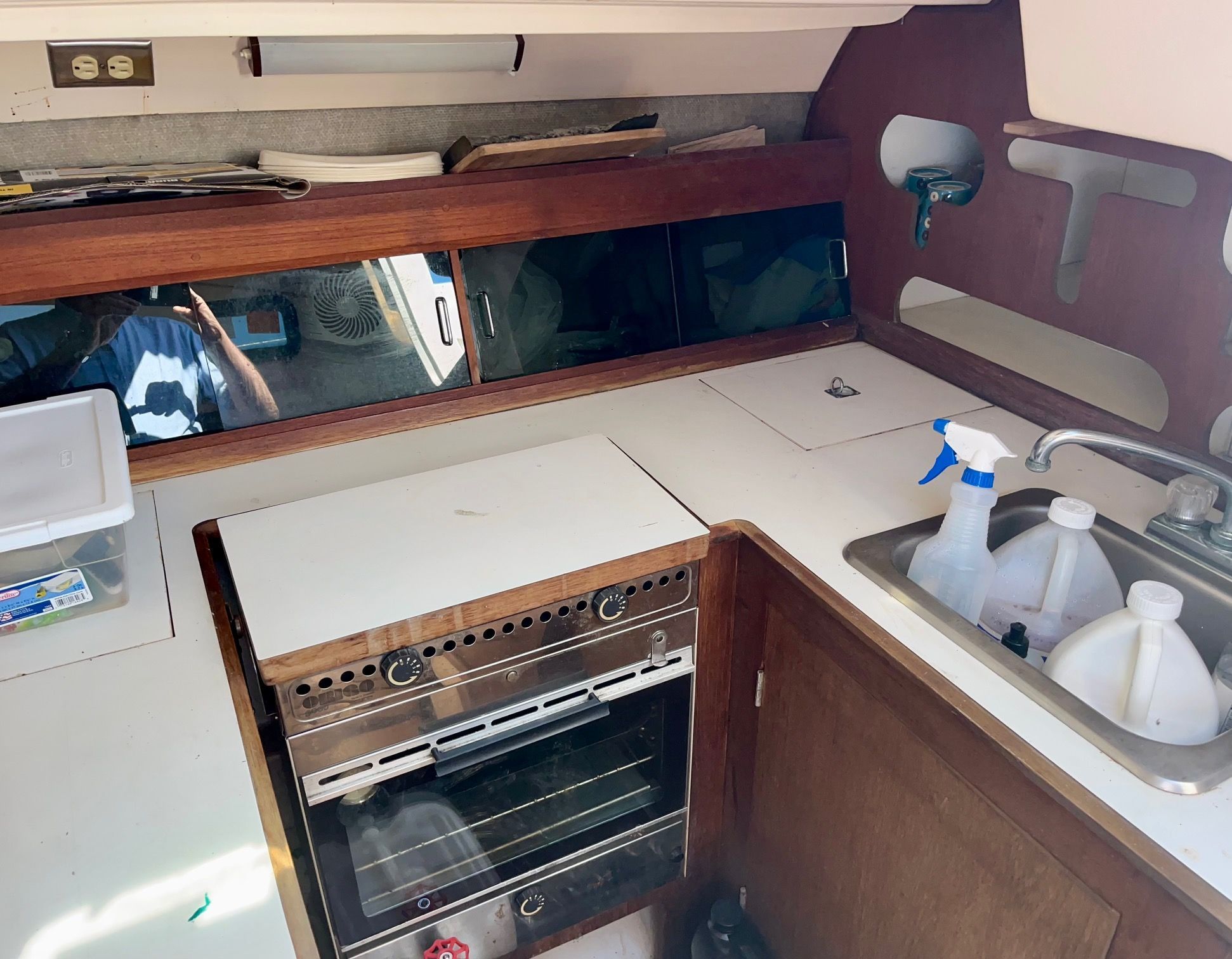 Interior of a 1985 Hunter 30 featuring a kitchen area with stove and sink.