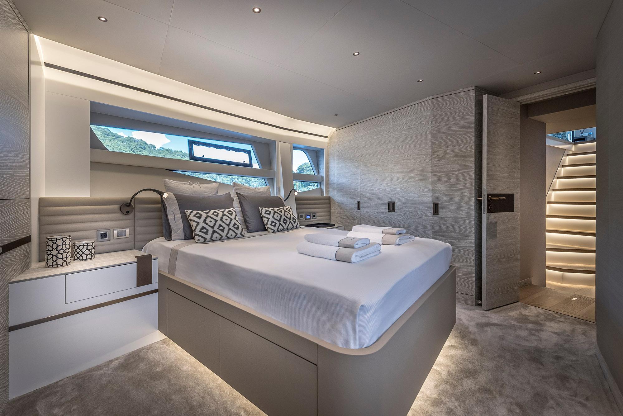 Luxurious bedroom interior of 2025 Numarine 26XP yacht with modern design and ambient lighting.