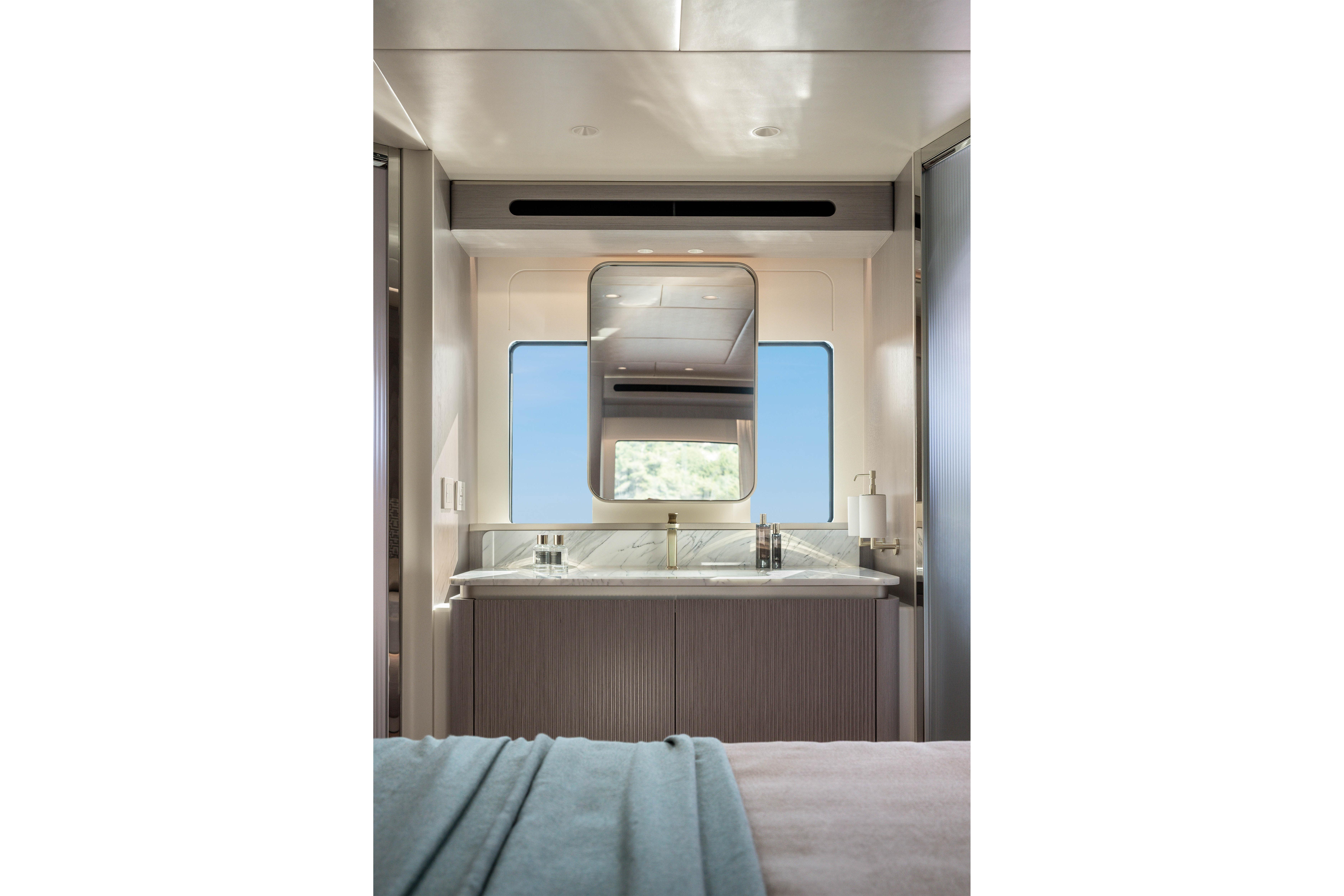 Interior of a modern boat with a sink and mirror.