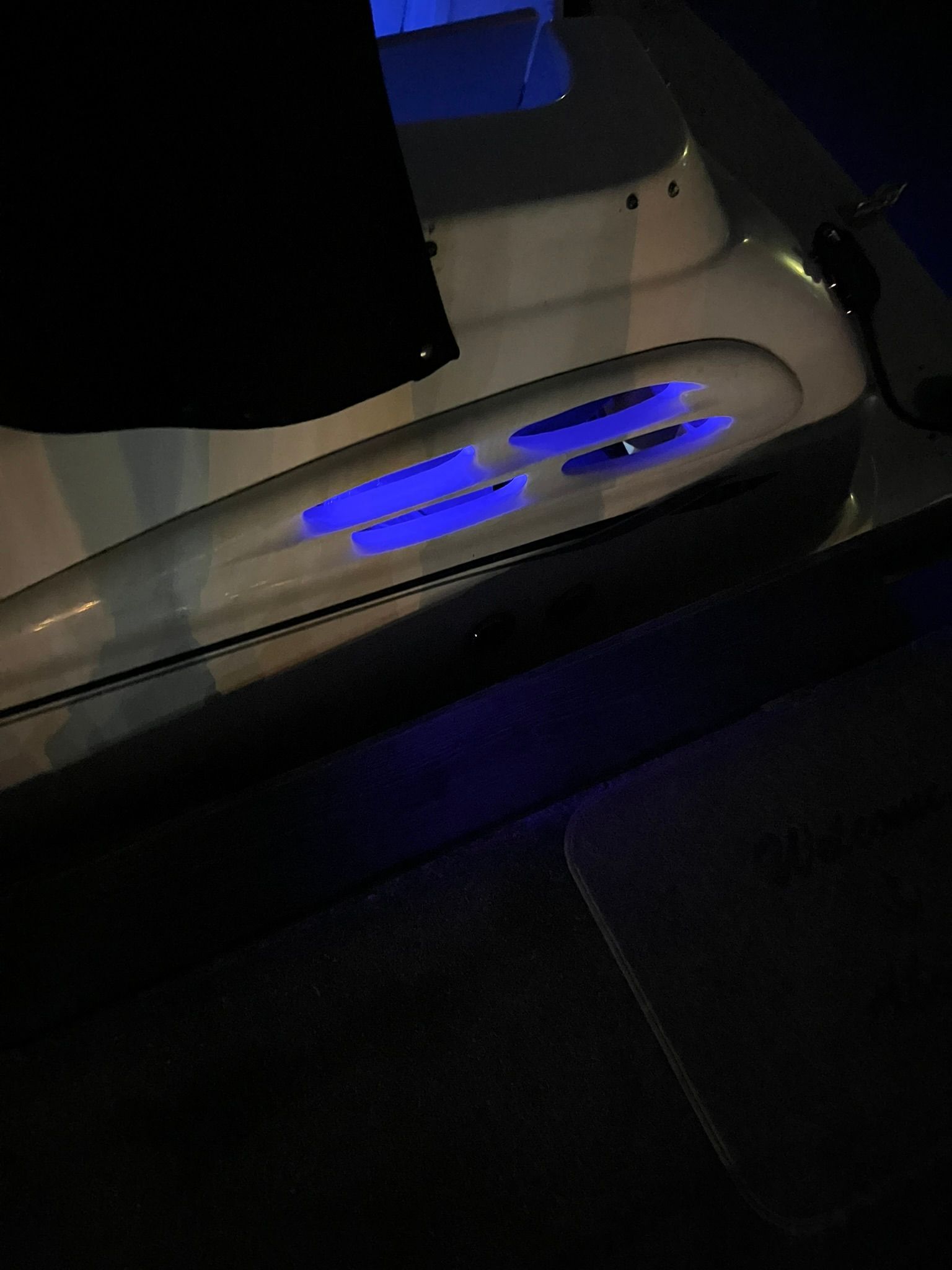 Chaparral Signature 2000 boat with blue lighting at night.