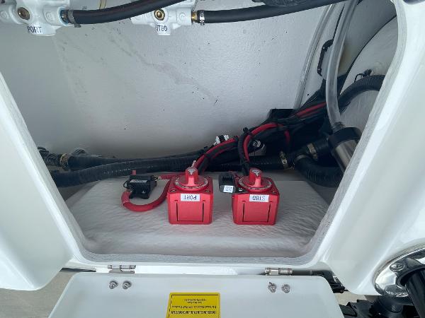 Battery compartment of 2026 Cape Horn 24XS boat with red batteries and wiring.