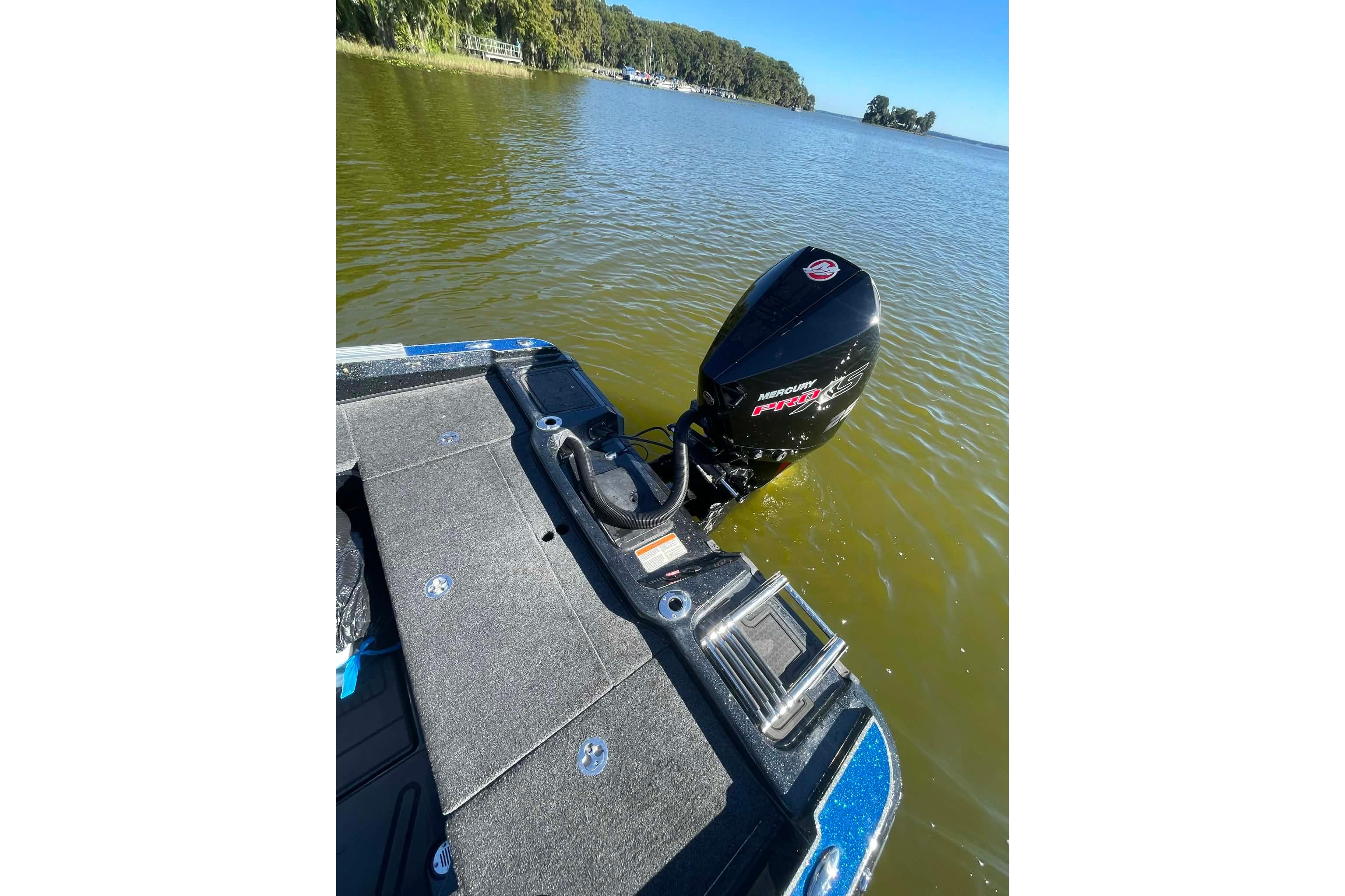 2024 Nitro ZV21 boat with Mercury Pro XS engine on a calm lake.