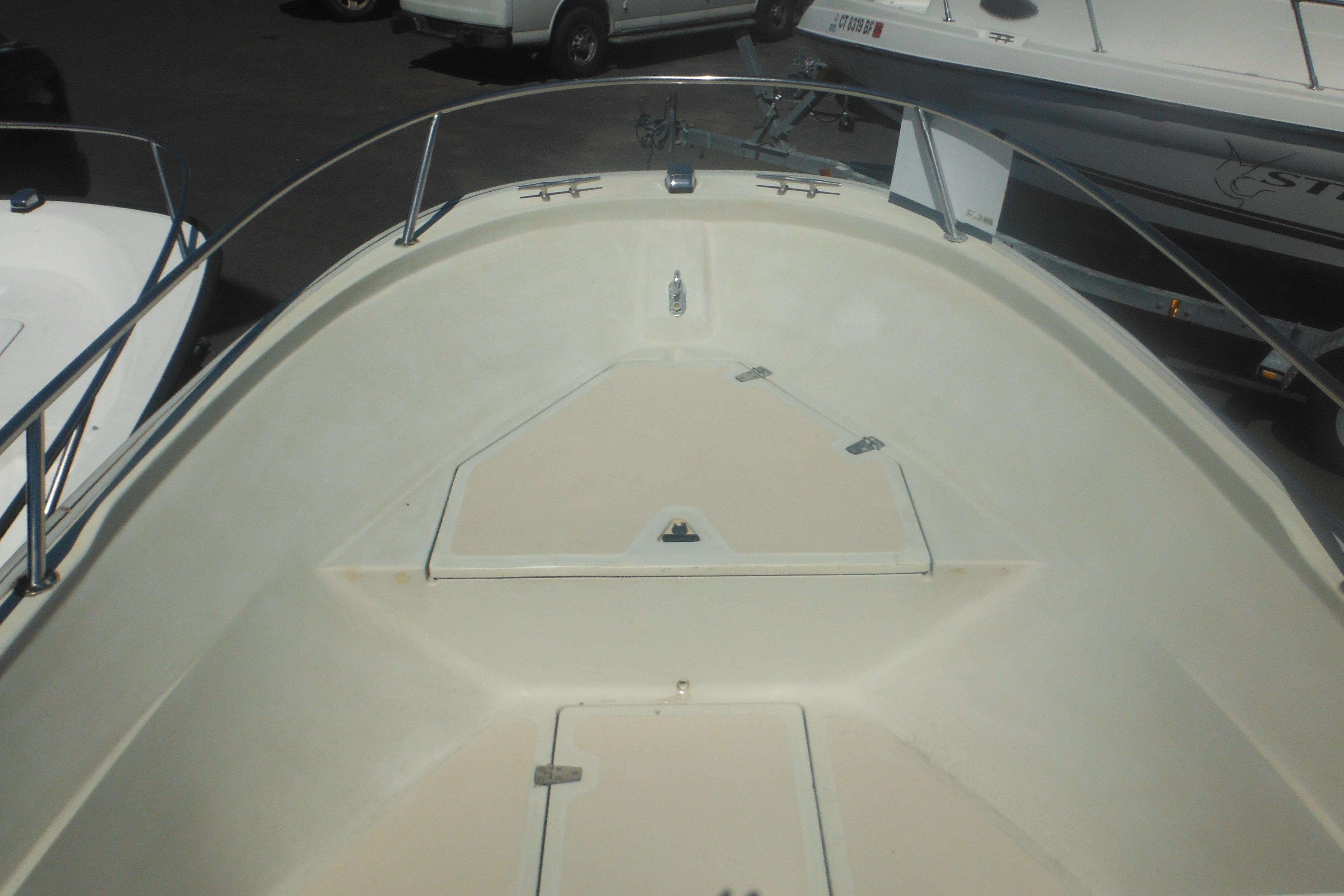 1991 Boston Whaler 16 SL boat interior with storage compartments and railing.