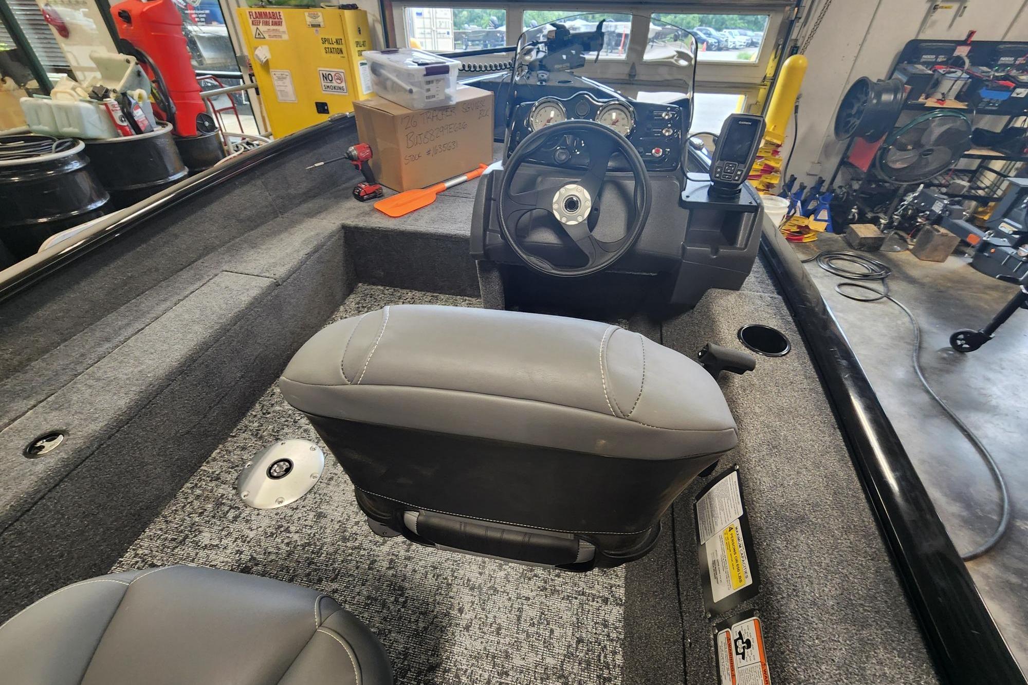 2026 Tracker Super Guide V-16 SC boat interior with steering wheel and seating.