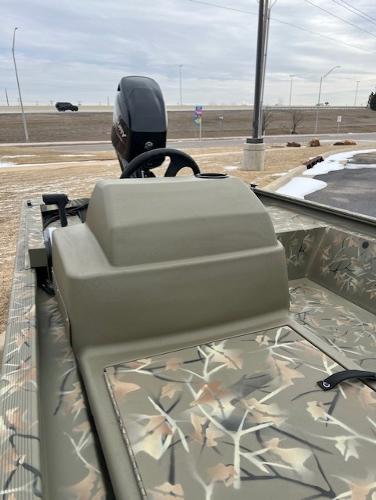 2025 Tracker Grizzly 1648 SC boat with camouflage design, steering console, and outboard motor.
