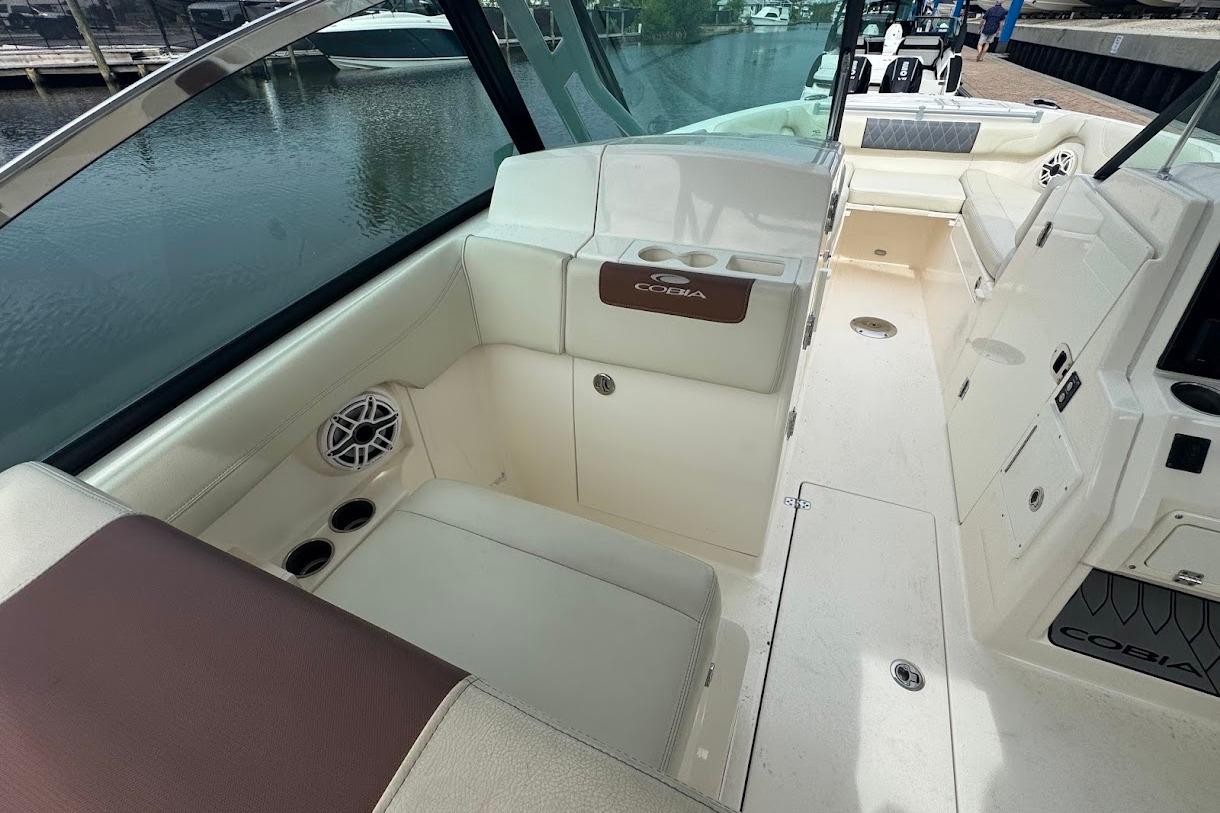 2020 Cobia 280 Dual Console boat interior with seating and cup holders.