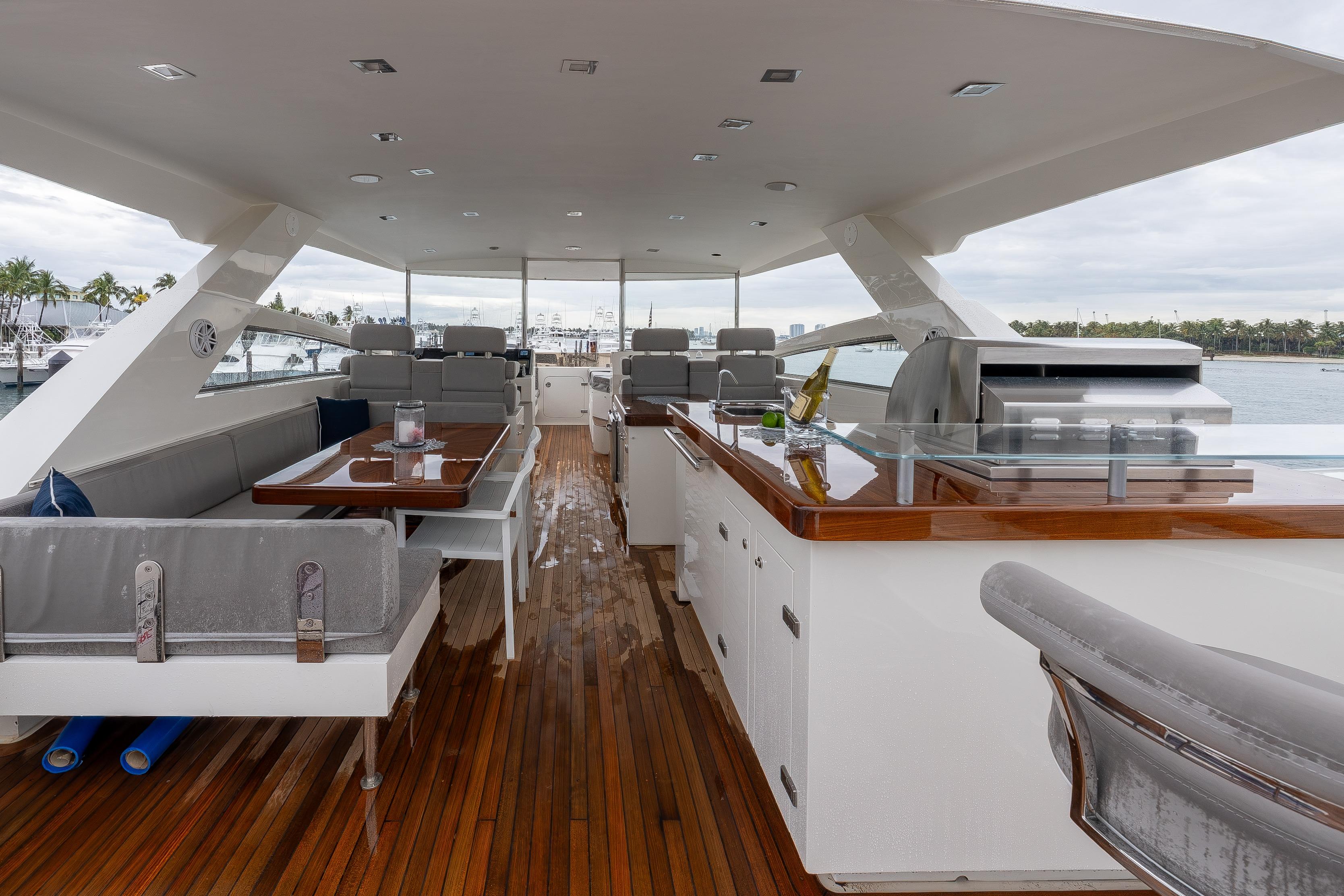 Luxurious 2012 Lazzara Breeze yacht deck with seating, dining area, and grill.