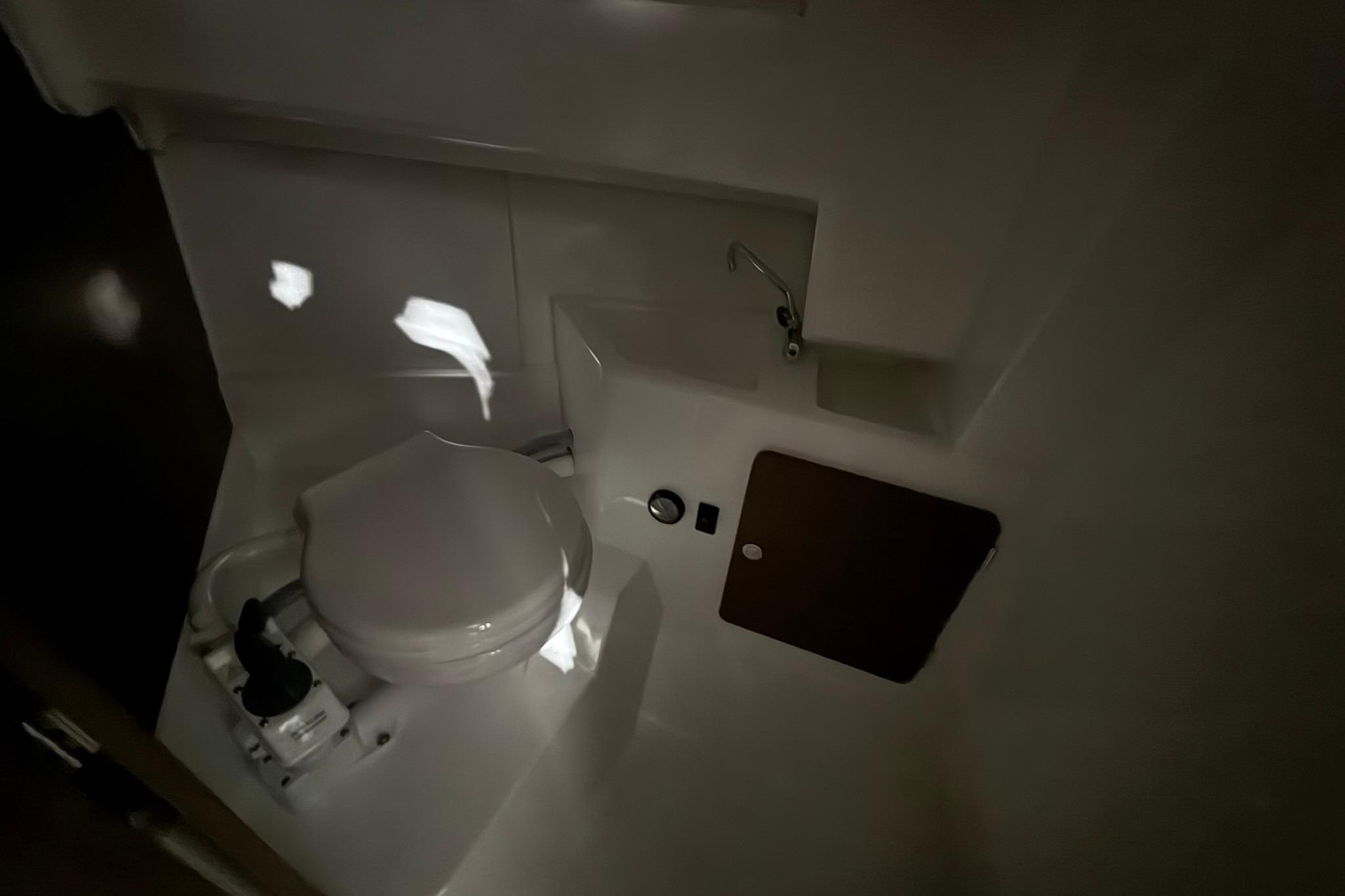2024 Jeanneau NC Sport 795 Series 2 boat bathroom interior with toilet and sink.