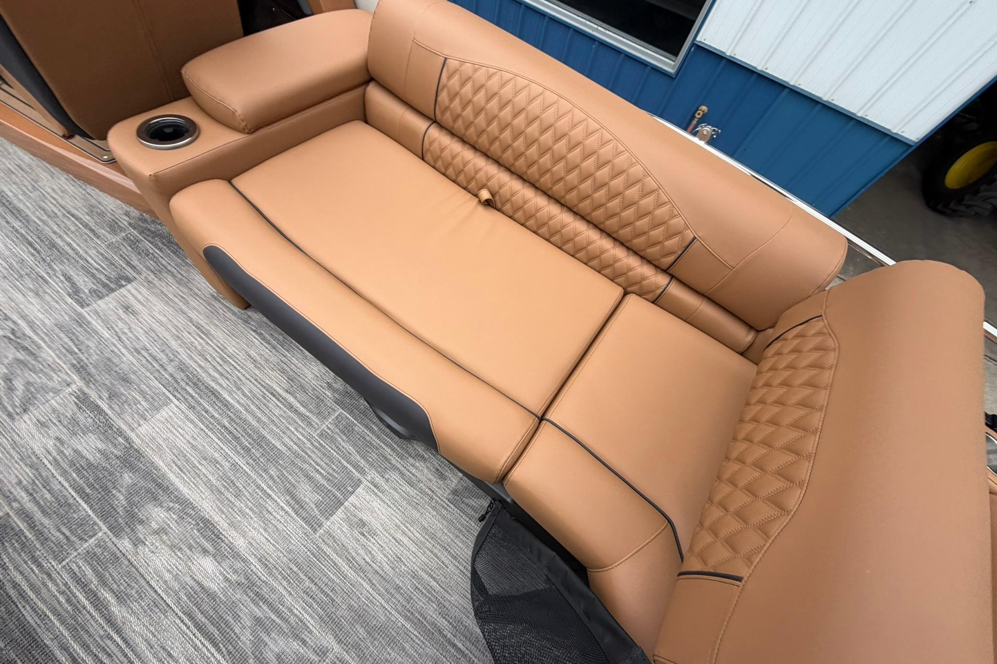 Luxurious tan seating on 2026 Avalon Catalina Quad Lounge Shift boat.