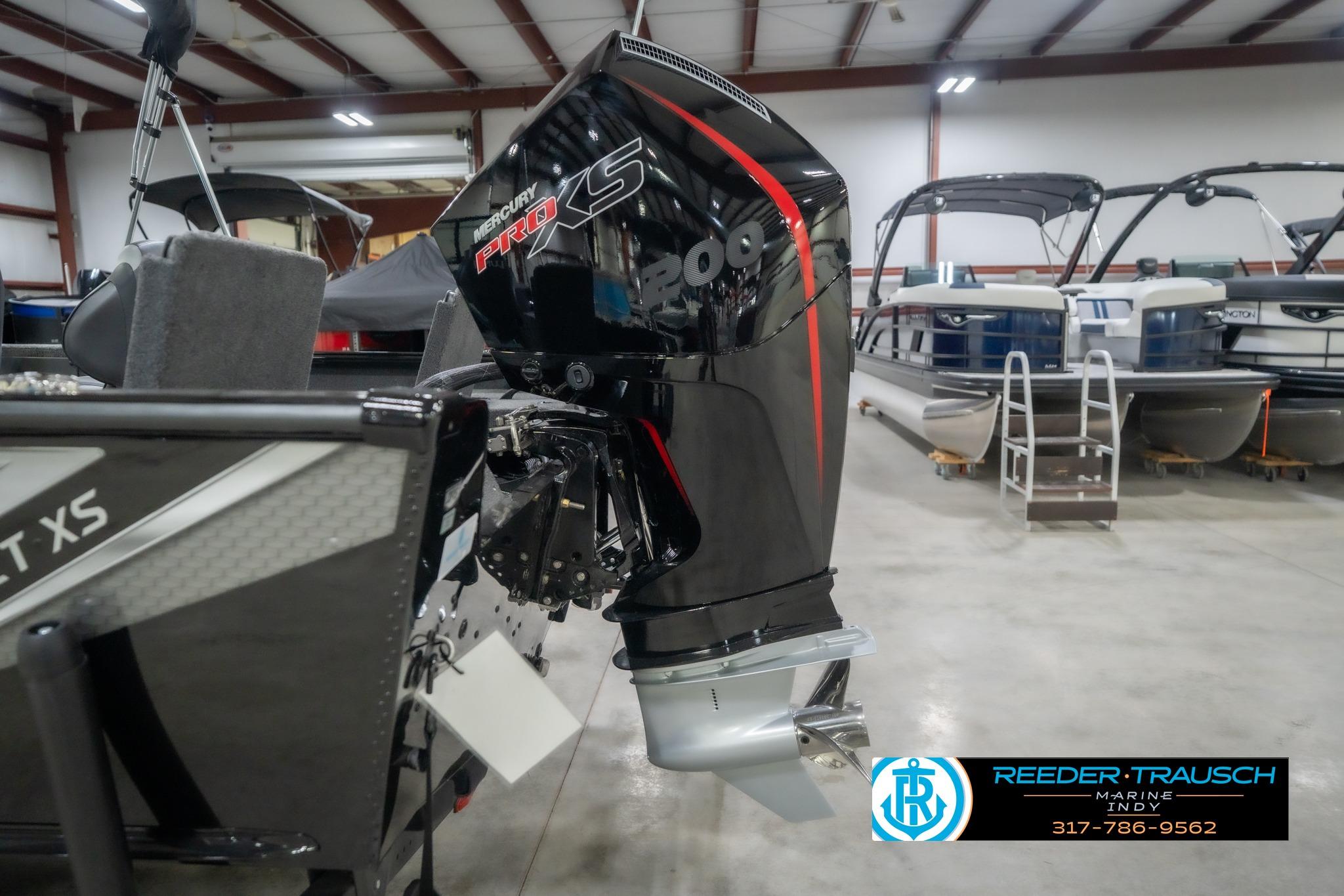 2026 Lund 2075 Impact XS boat with Mercury Pro XS engine in showroom.