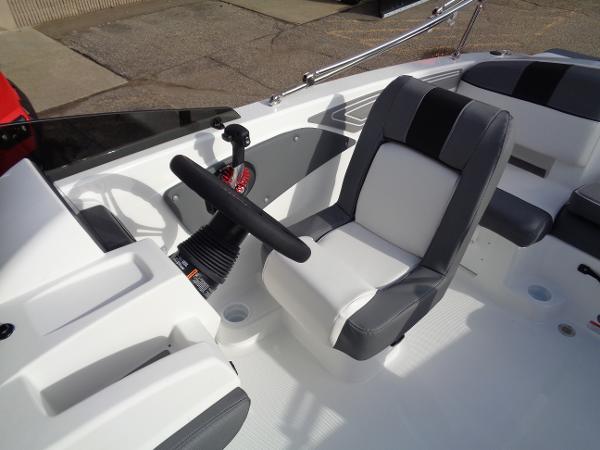 2024 Tahoe T21 boat interior with steering wheel and captain's chair.