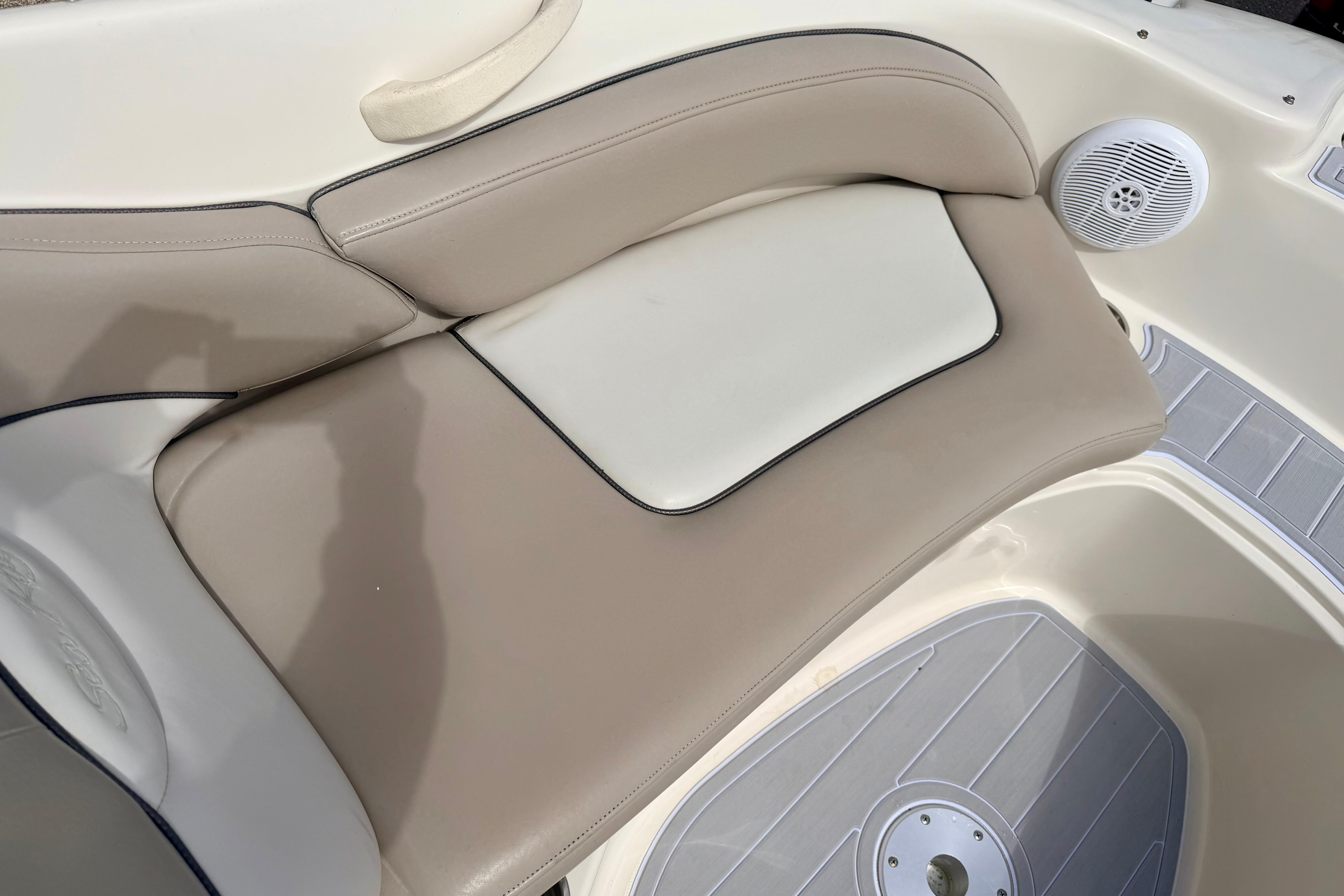 2003 Sea Ray 200 Sundeck boat interior with beige seating and speaker detail.