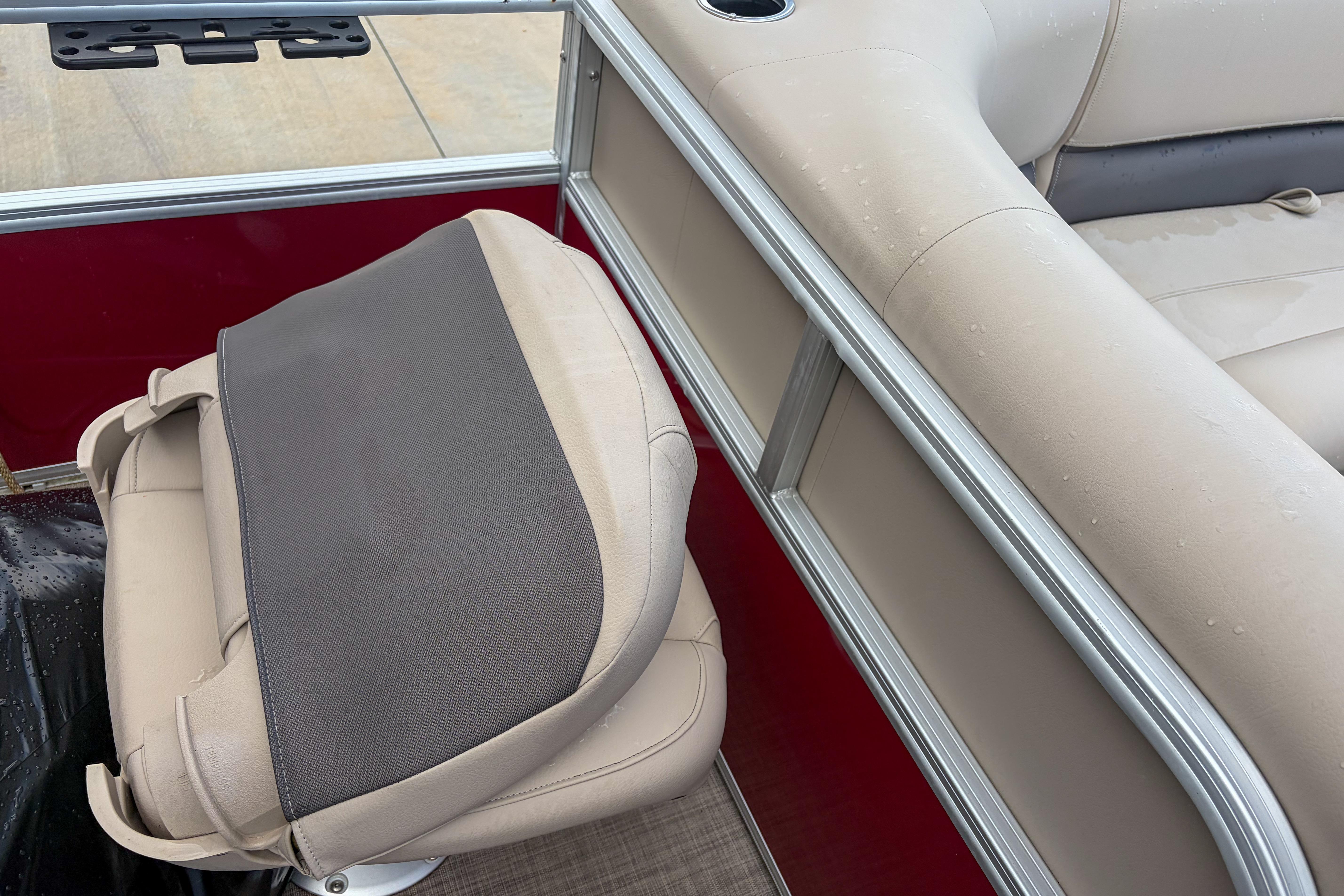 2024 Sun Tracker Bass Buggy 18 DLX boat interior with beige seating and red paneling.