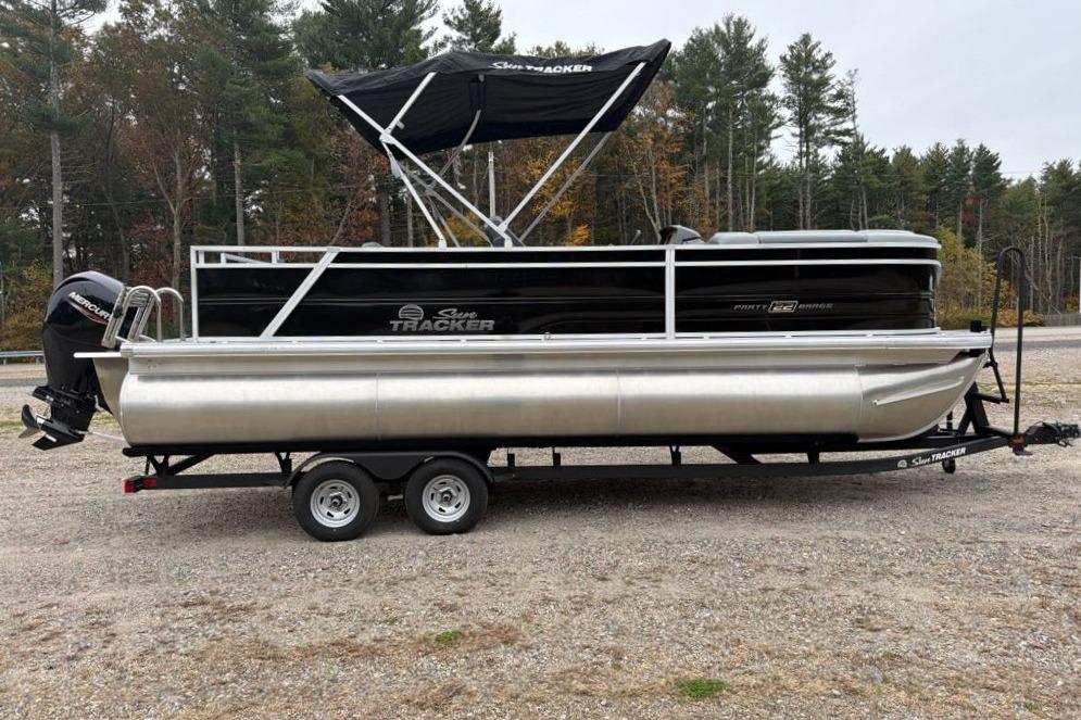 2026 Sun Tracker Party Barge 22 RF XP3 pontoon boat on trailer, parked outdoors.