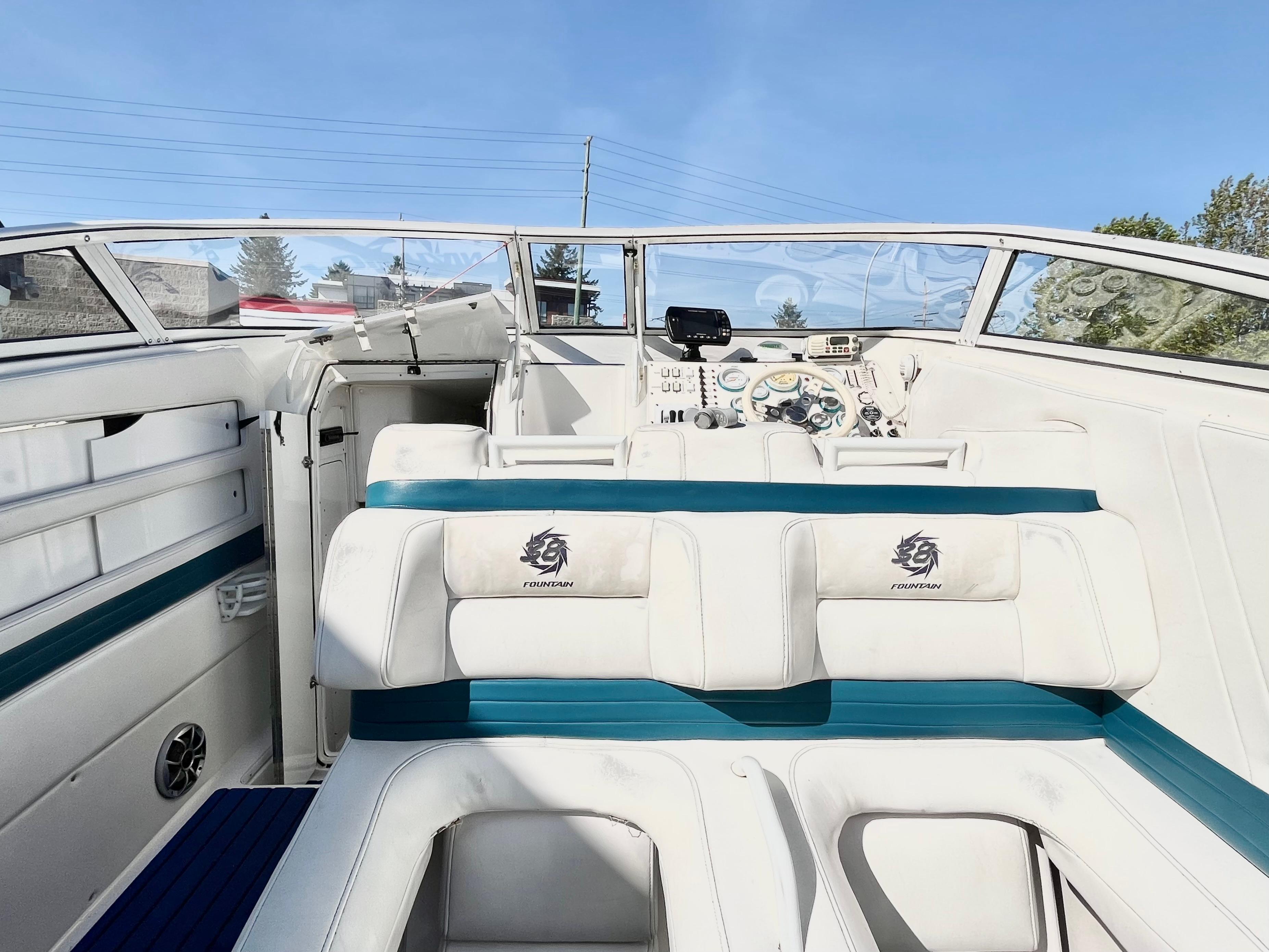 1999 Fountain 38 Sport Cruiser interior with white seating and dashboard view.