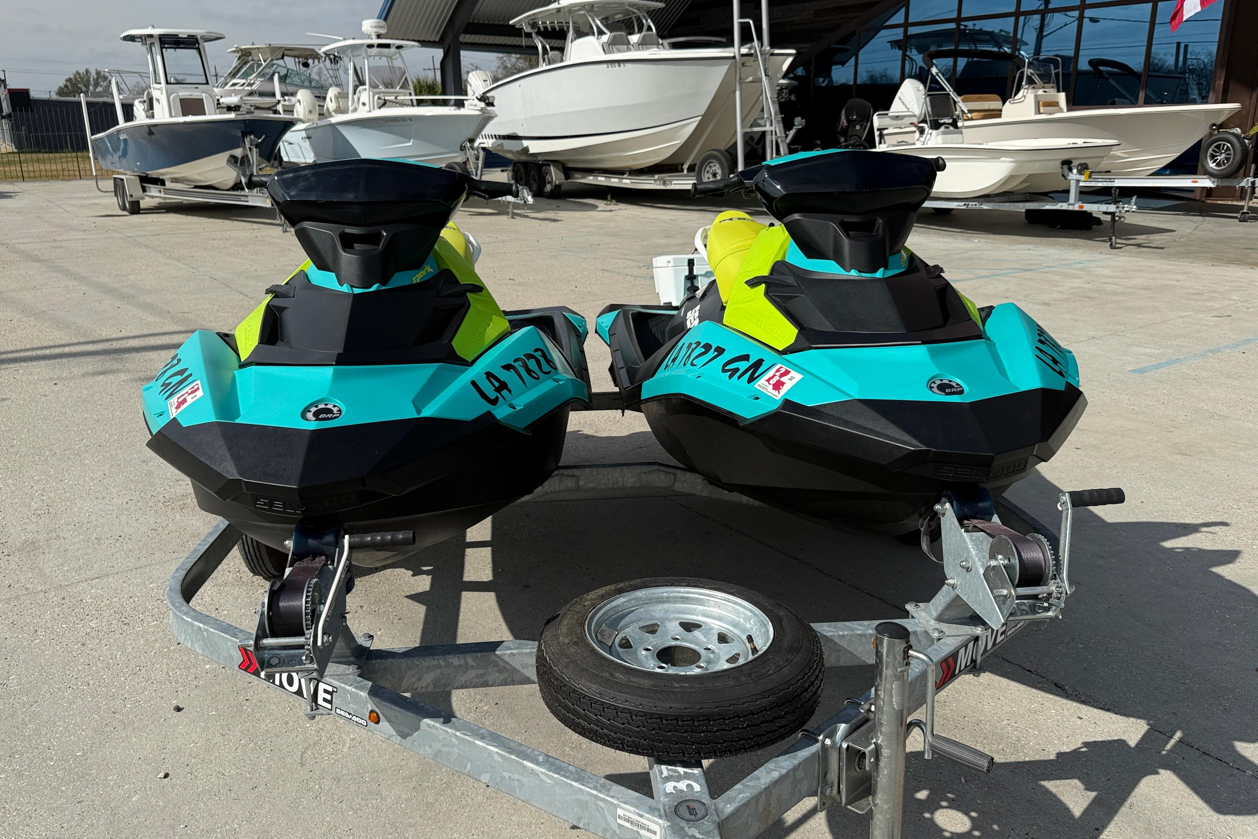 2022 Sea-Doo Spark 3up jet skis on trailer, vibrant colors, parked outdoors.