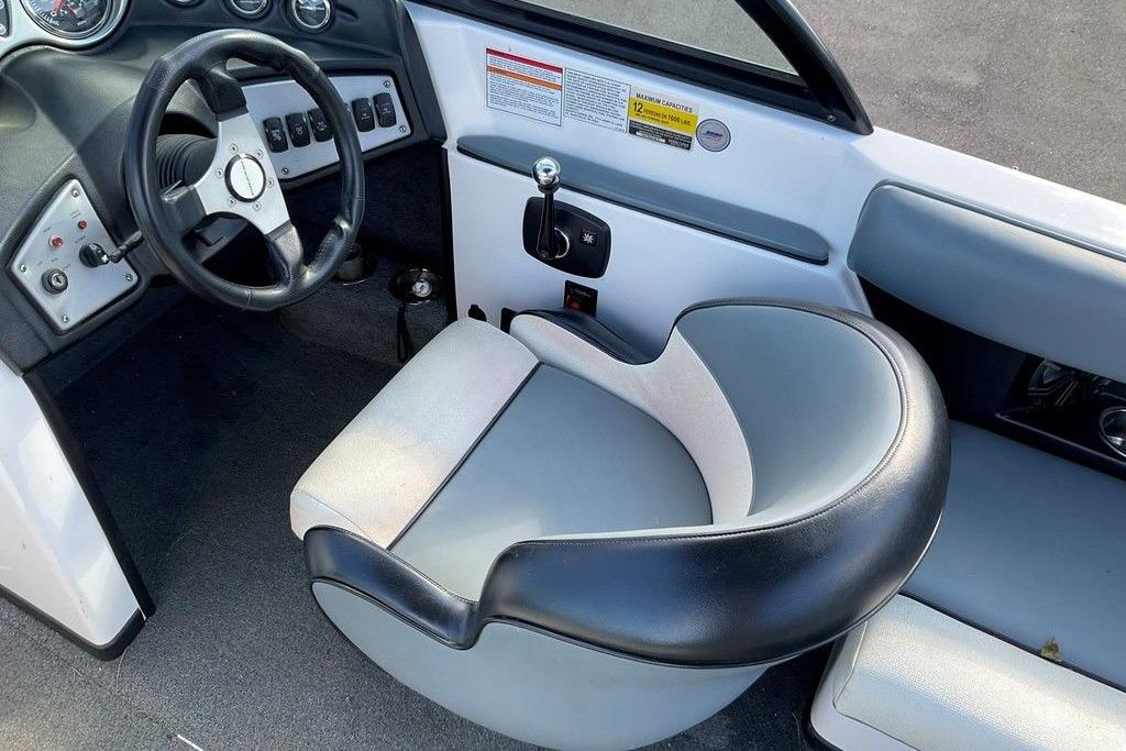 2015 Moomba Outback V boat interior with steering wheel and captain's chair.