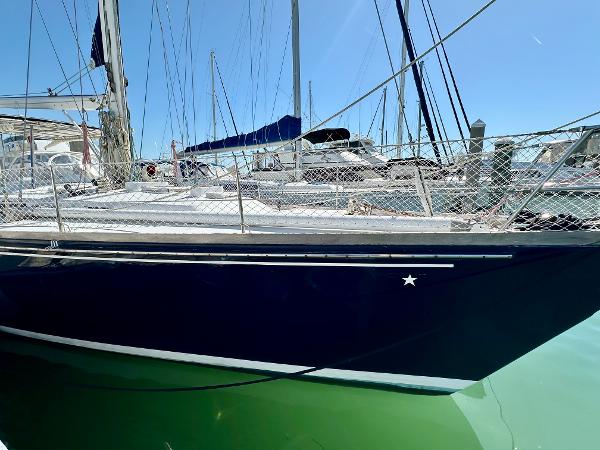 1989 Concordia 52 sailboat docked at marina, side view.