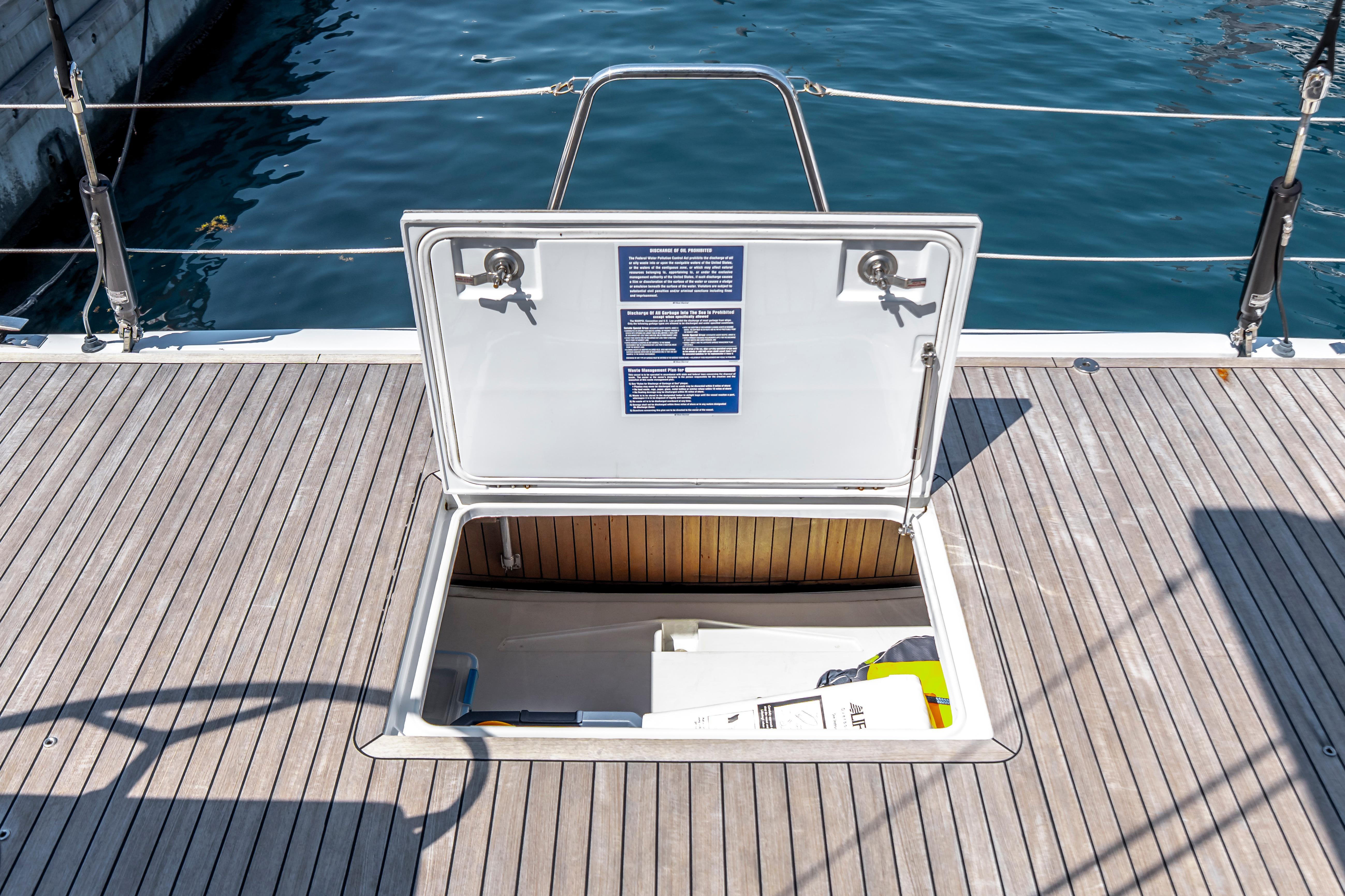 Open hatch on 2016 Grand Soleil 58 yacht deck, revealing storage compartment.