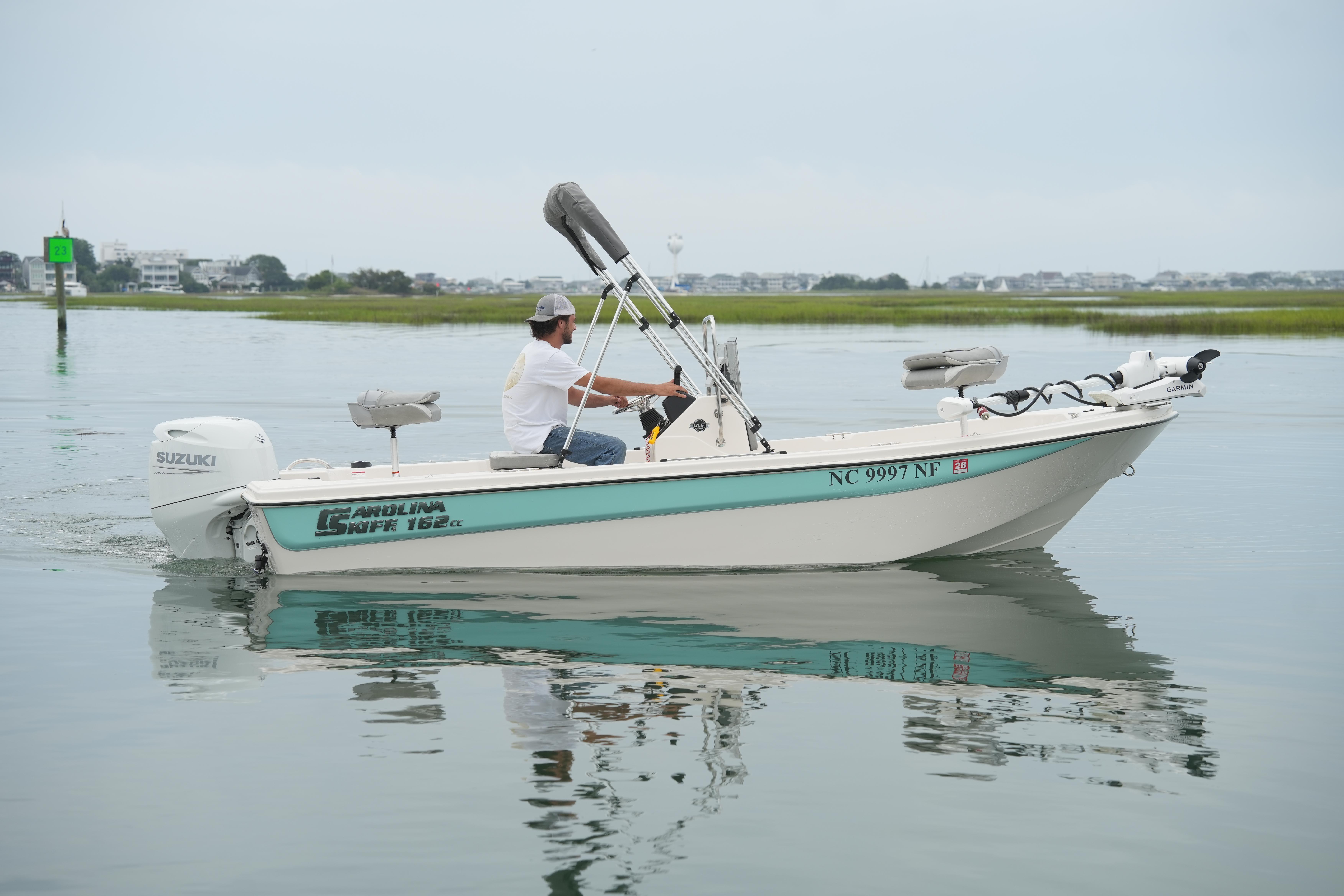 2025 Carolina Skiff 162 JLS boat on calm water with driver.