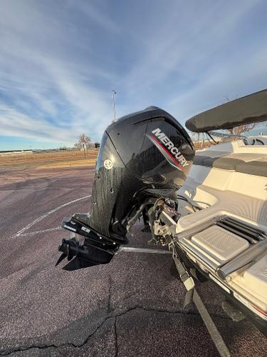 2023 Tahoe T16 boat with Mercury outboard motor in a parking lot.