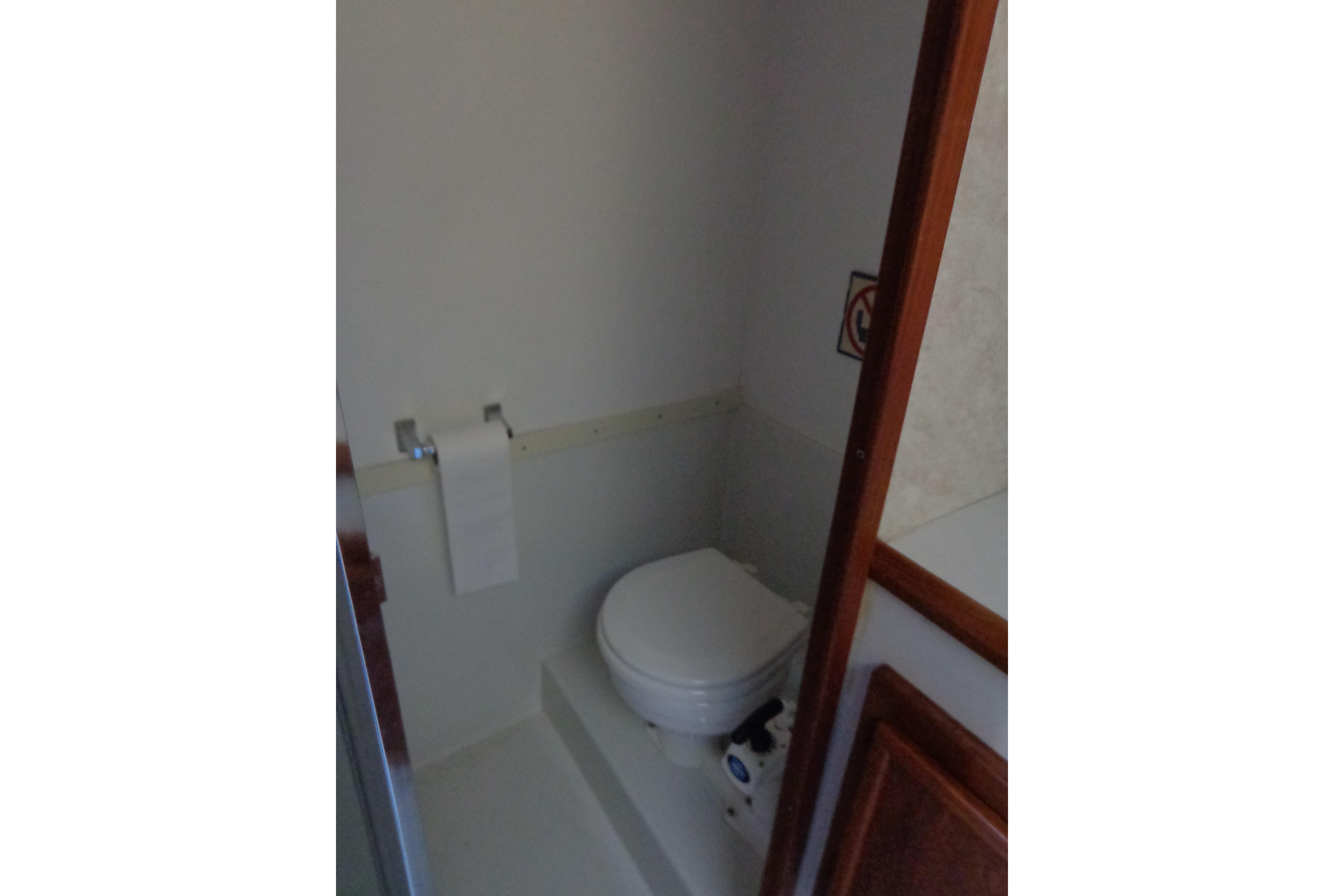 Bathroom interior of 1992 Cruise-A-Home Corsair 4200 with toilet and paper holder.