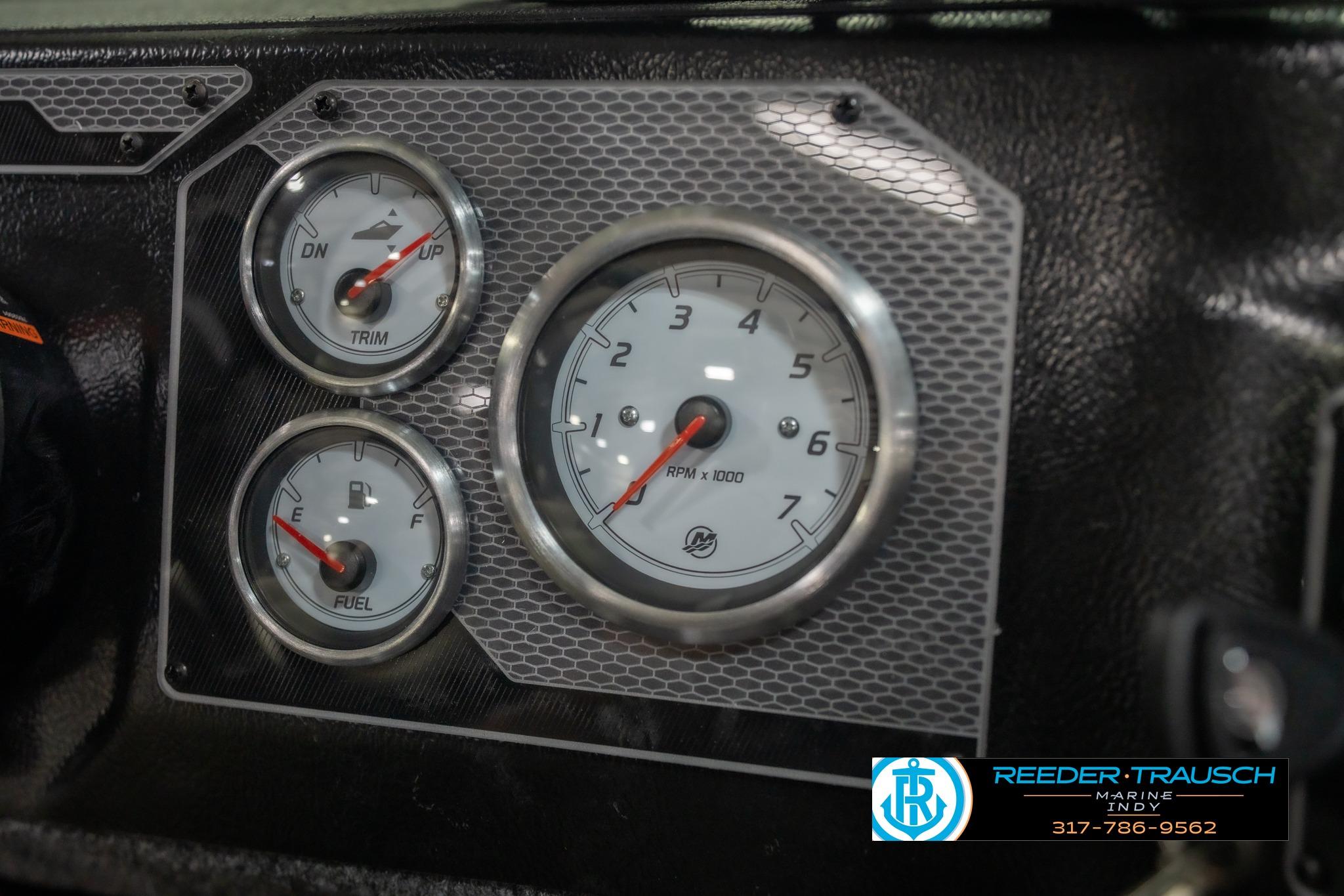 Dashboard gauges of 2026 Lund 2075 Impact XS boat, featuring trim, RPM, and fuel indicators.